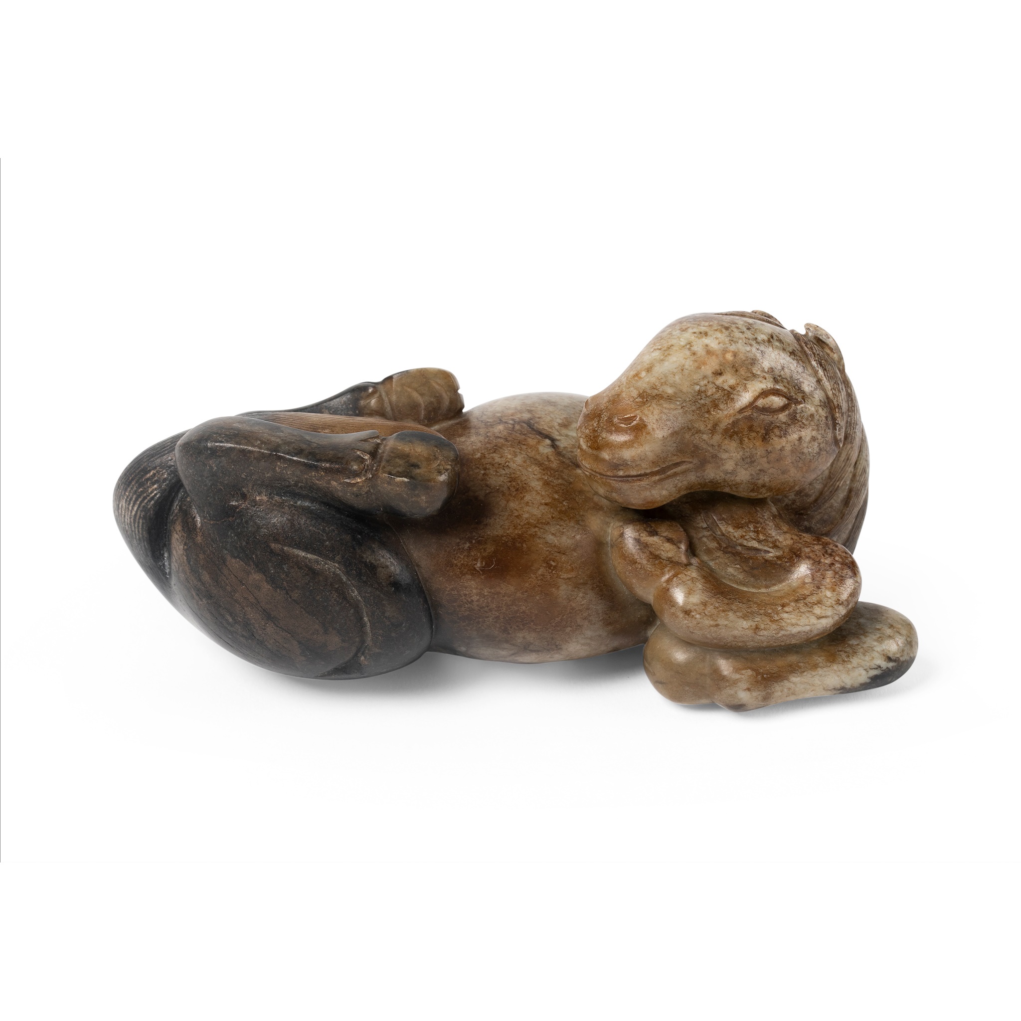 'CHICKEN BONE' JADE CARVING OF RECLINING HORSE