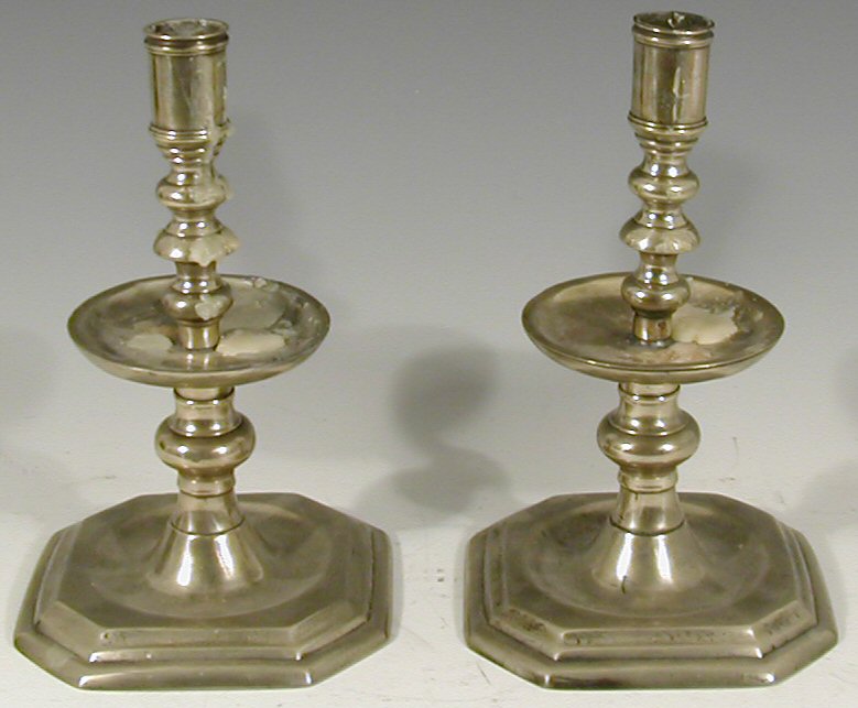 A pair of silvered brass table candlesticks,