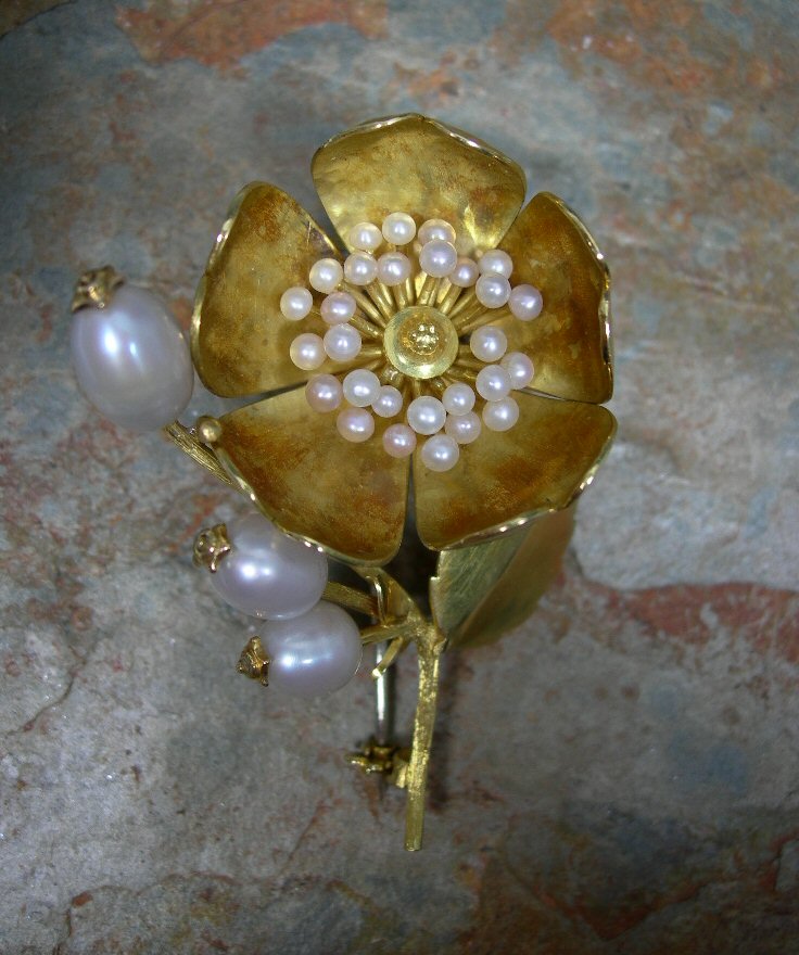 Cairncross - an 18ct gold mounted Scottish freshwater pearl set floral spray brooch,