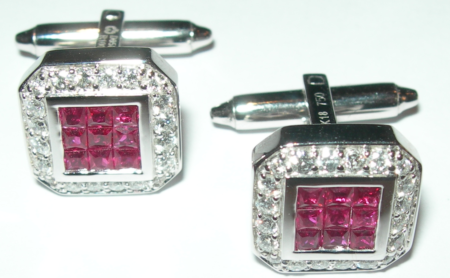 A pair of contemporary ruby and diamond set cuff links,