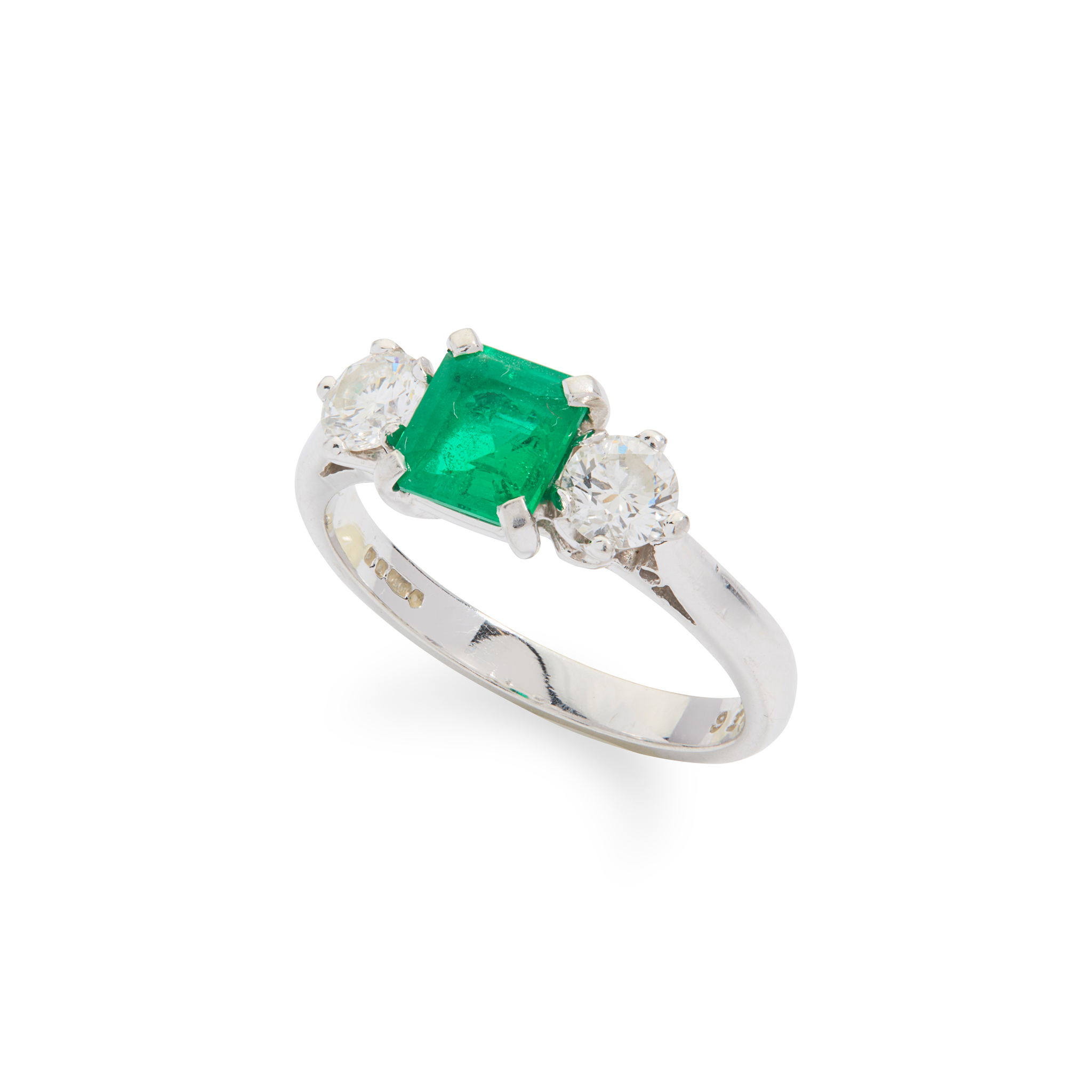A platinum emerald and diamond ring