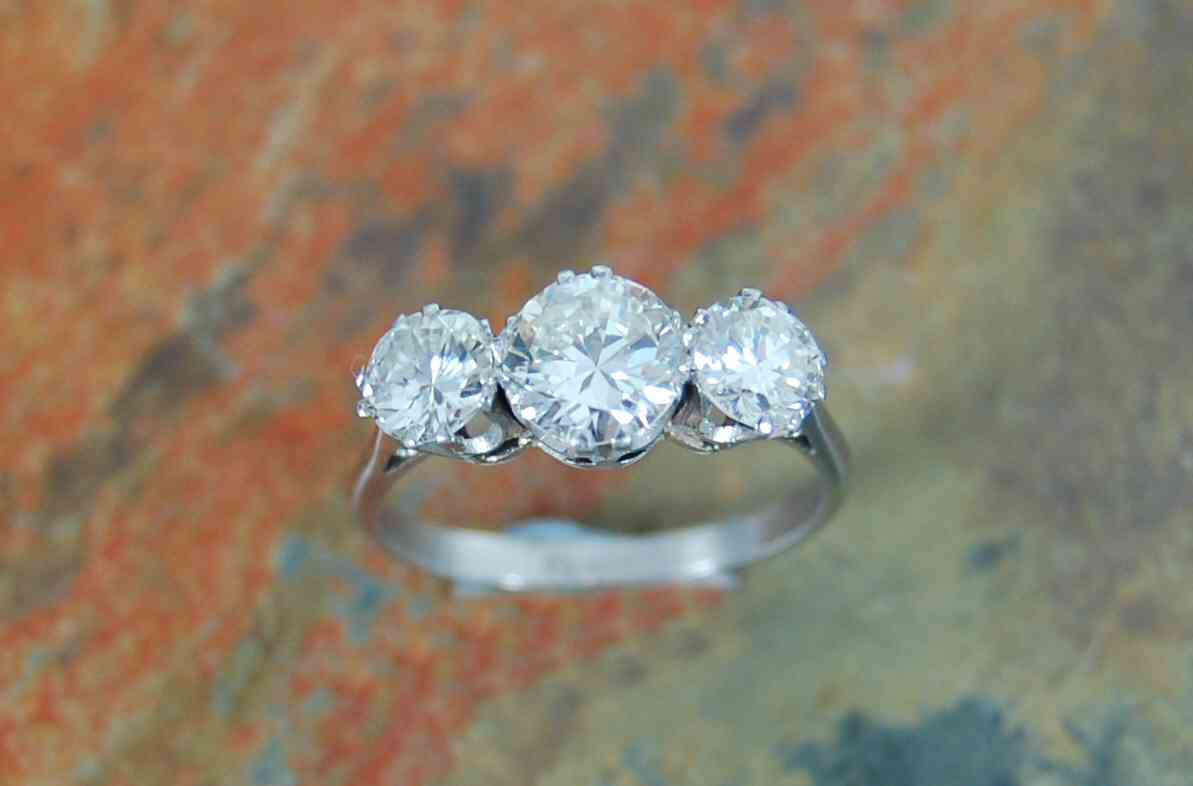 A platinum mounted three-stone diamond ring