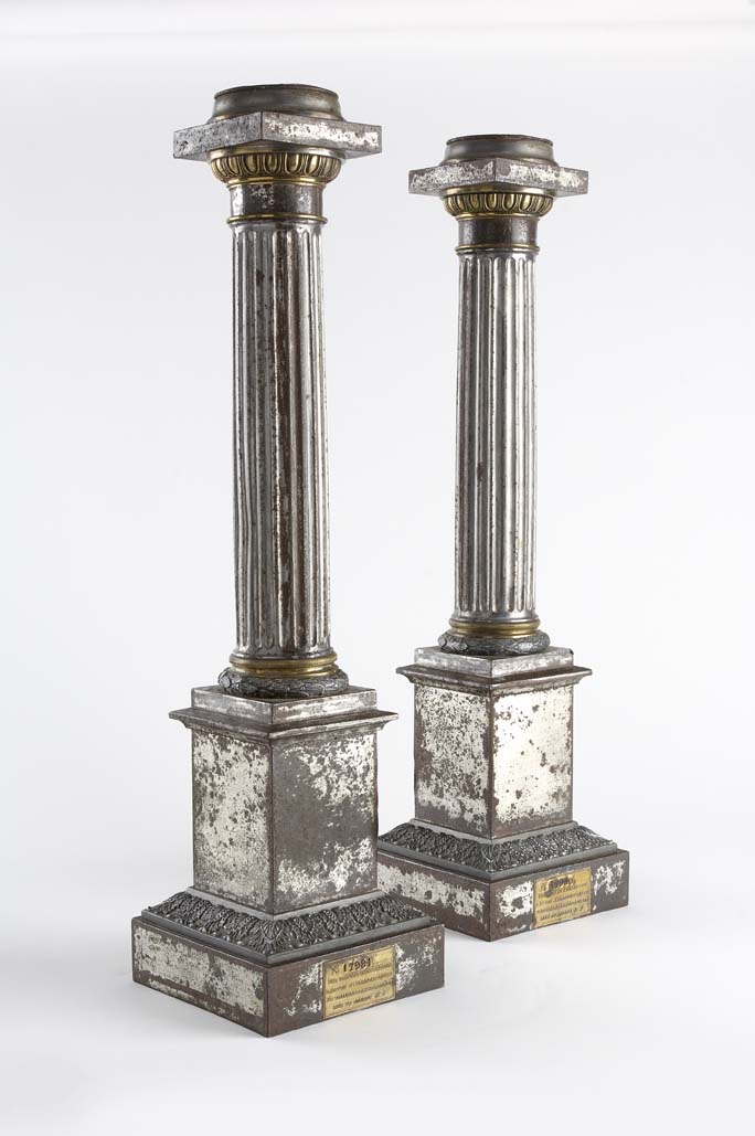A pair of French 19th century polished zinc lamps