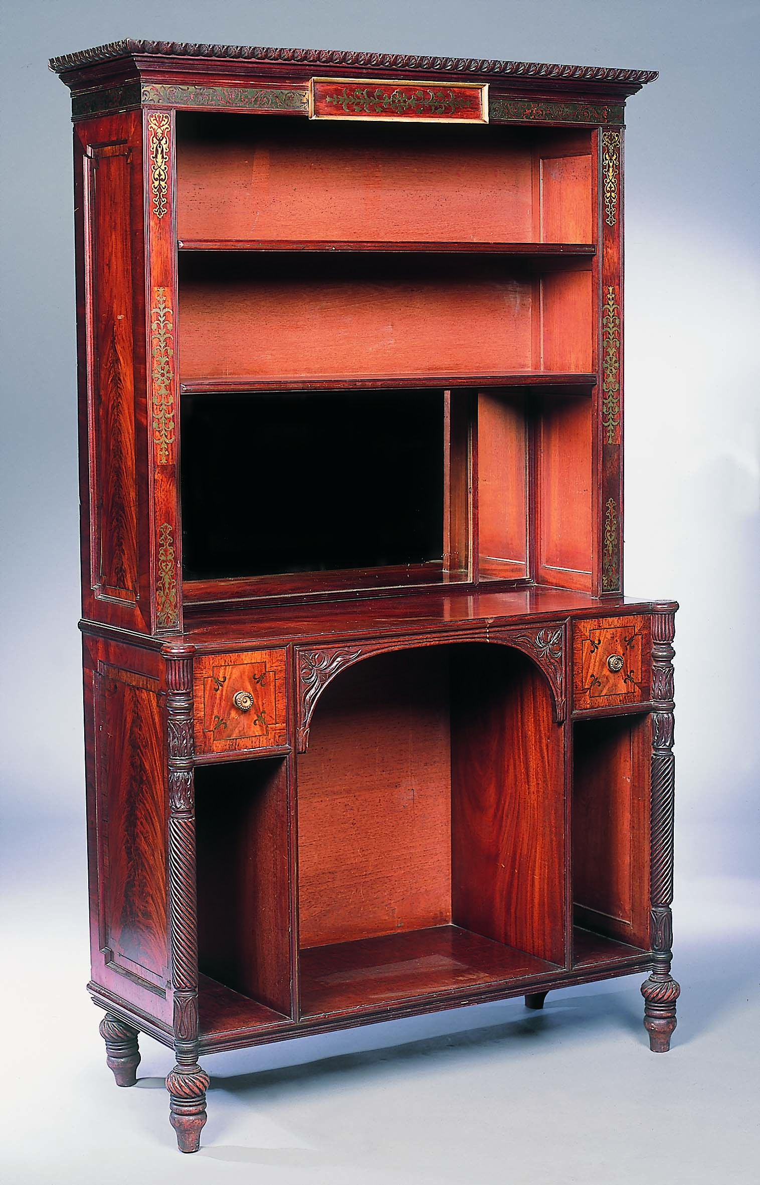 A Regency mahogany and brass inlaid bookcase cabinet