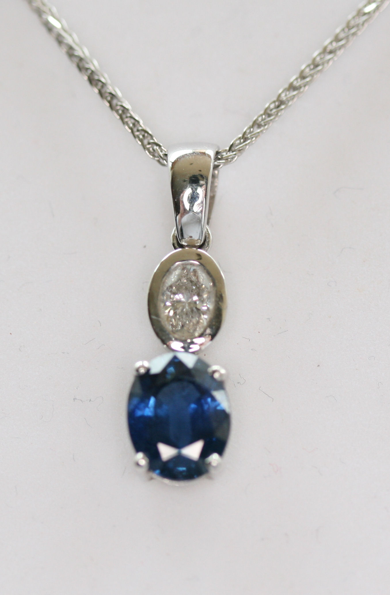 A sapphire and diamond set pendant with chain,