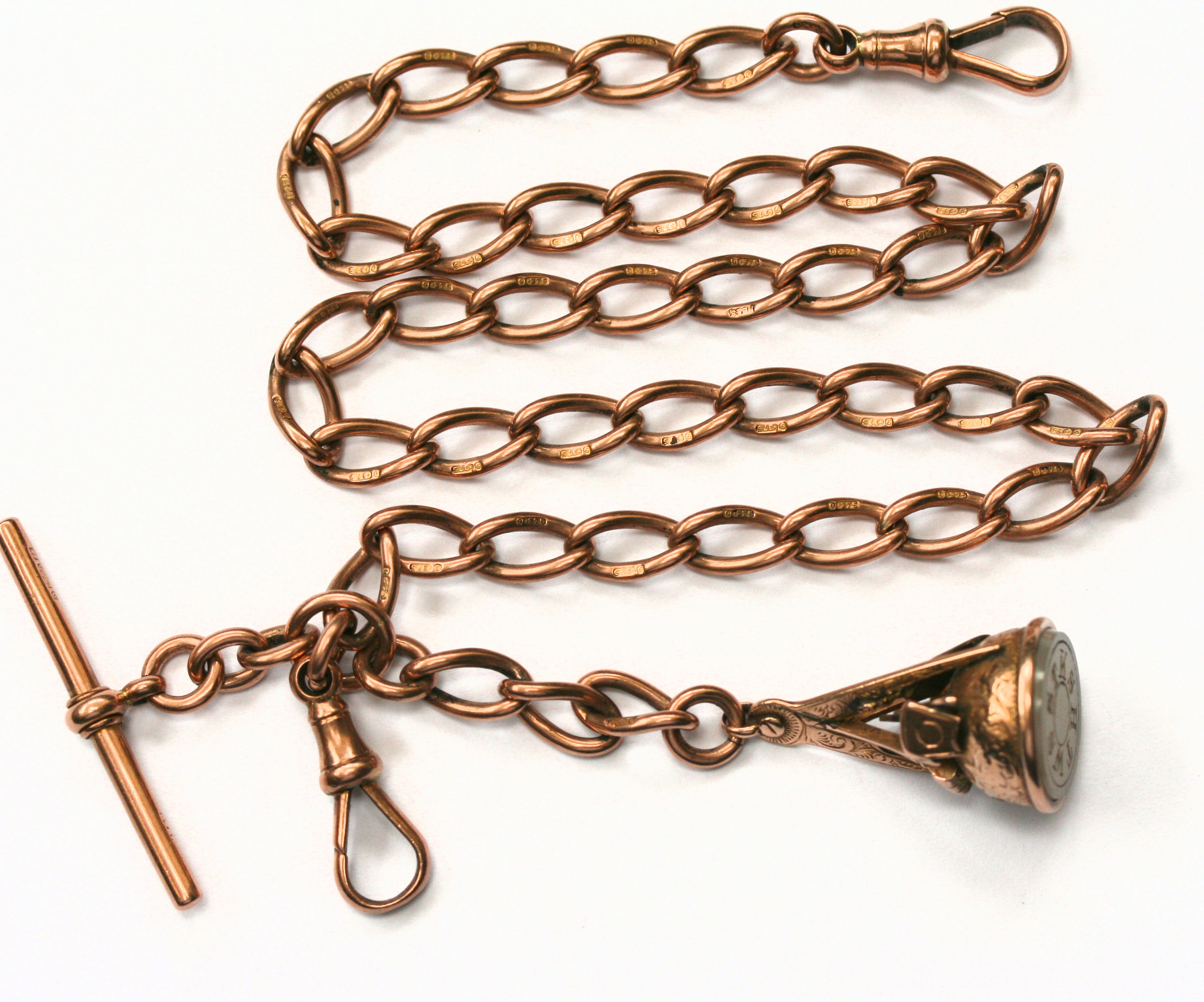 A 9ct rose gold Albert chain suspending a Masonic fob