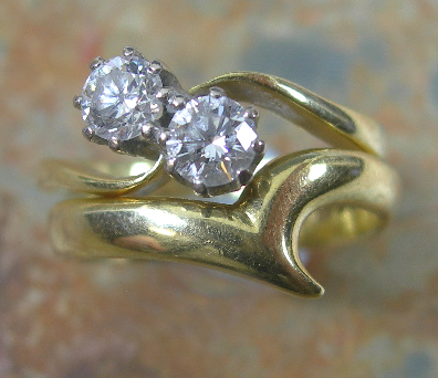 An 18ct gold mounted diamond two-stone ring,