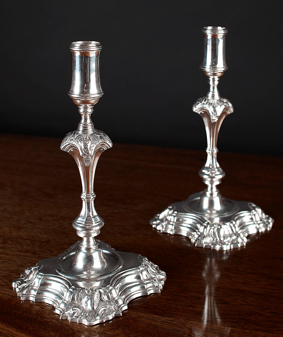 A scarce pair of George II cast candlesticks