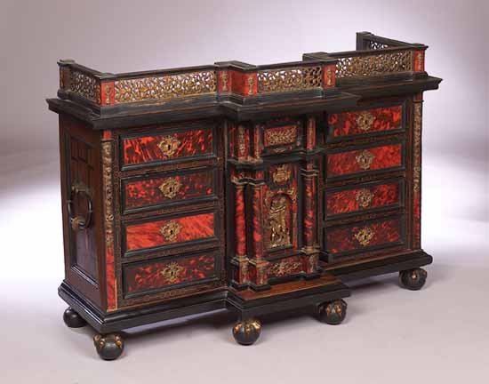 A red tortoiseshell and ebonised cabinet