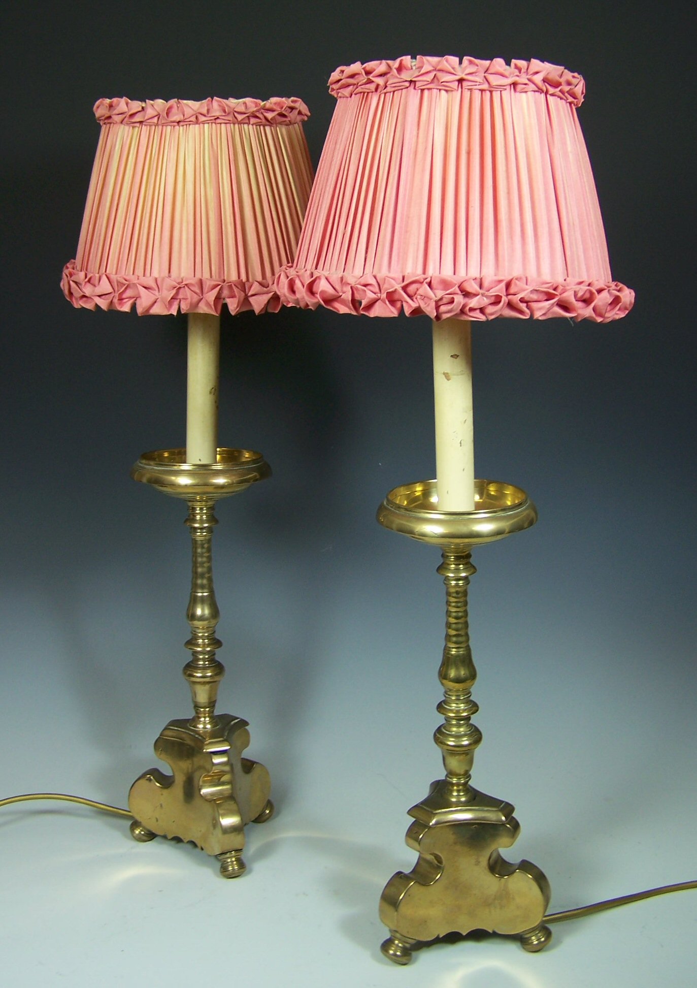 A pair of brass pricket candlesticks, converted to lamps
