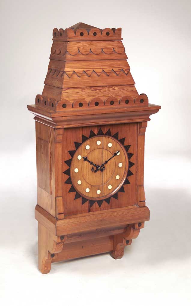 A mid 19th century Gothic Revival pitch pine wall clock,