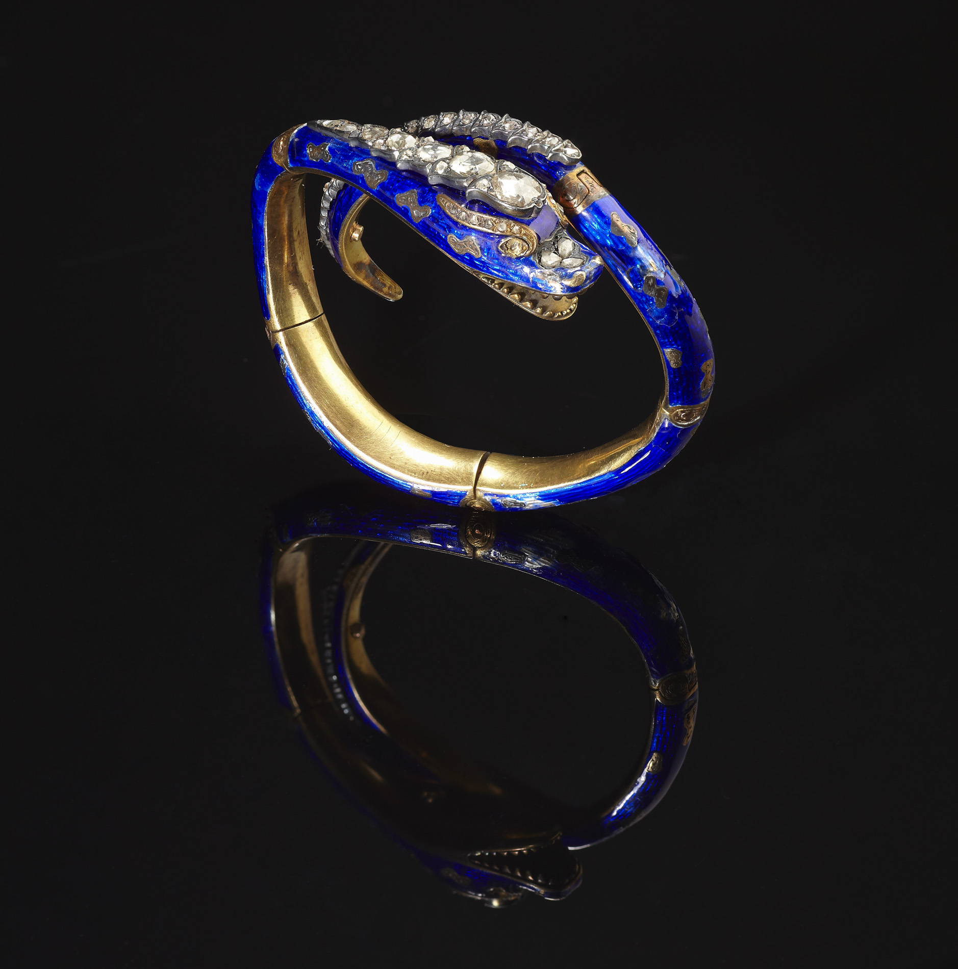 A mid 19th century diamond and enamel snake bangle