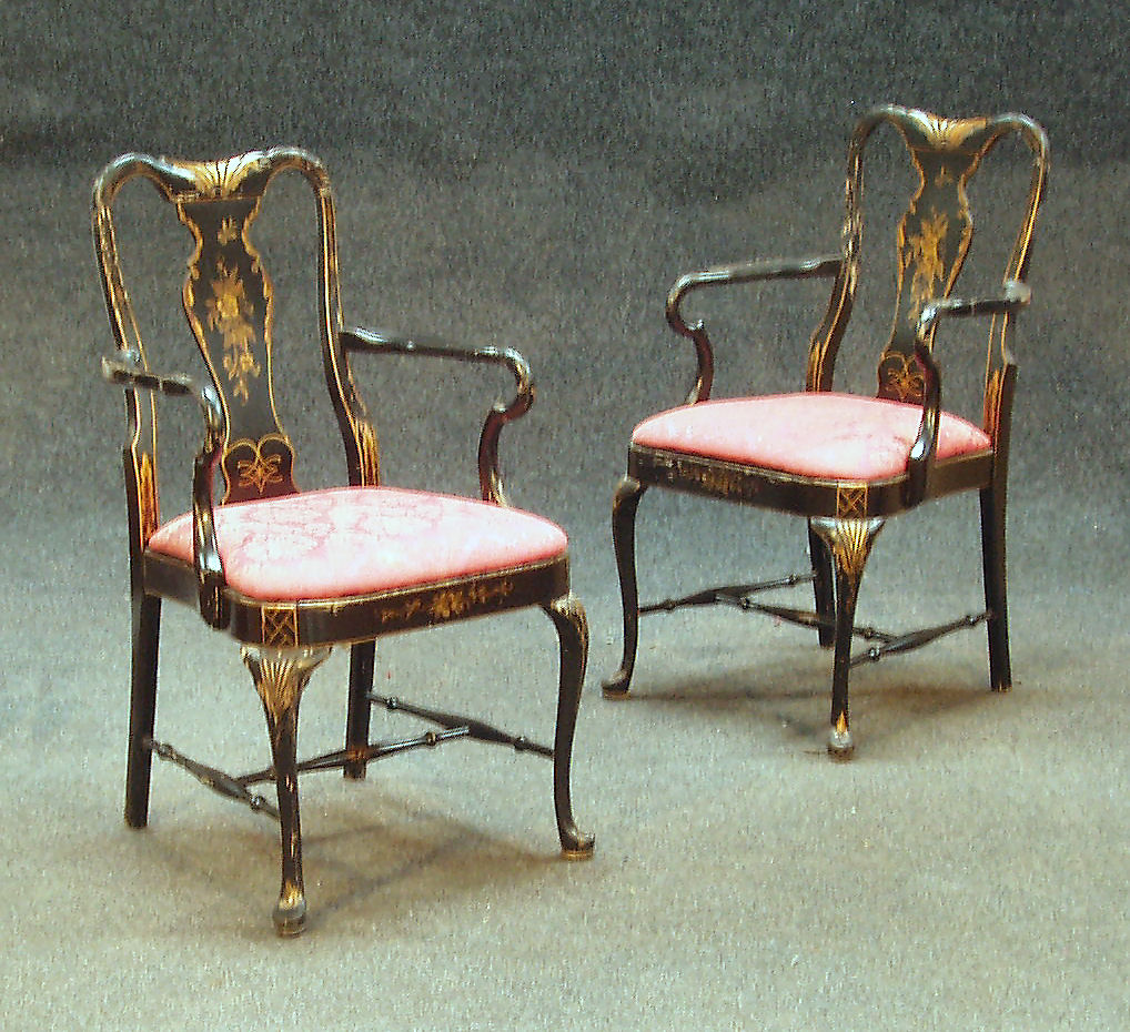 A pair of George II style black and gilt lacqured chinoiserie armchairs