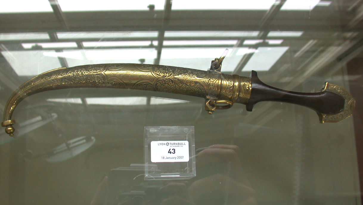 AN EGYPTIAN BRASS AND FOLIATE ENGRAVED DAGGER Presented to James McBey in 1917