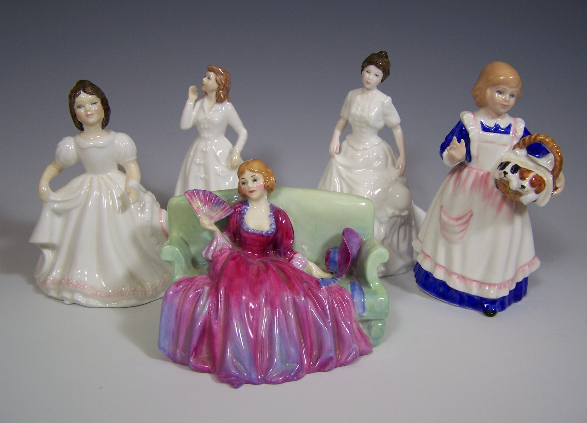 A collection of Royal Doulton figurines,