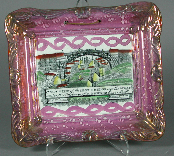 A rectangular pink lustre plaque