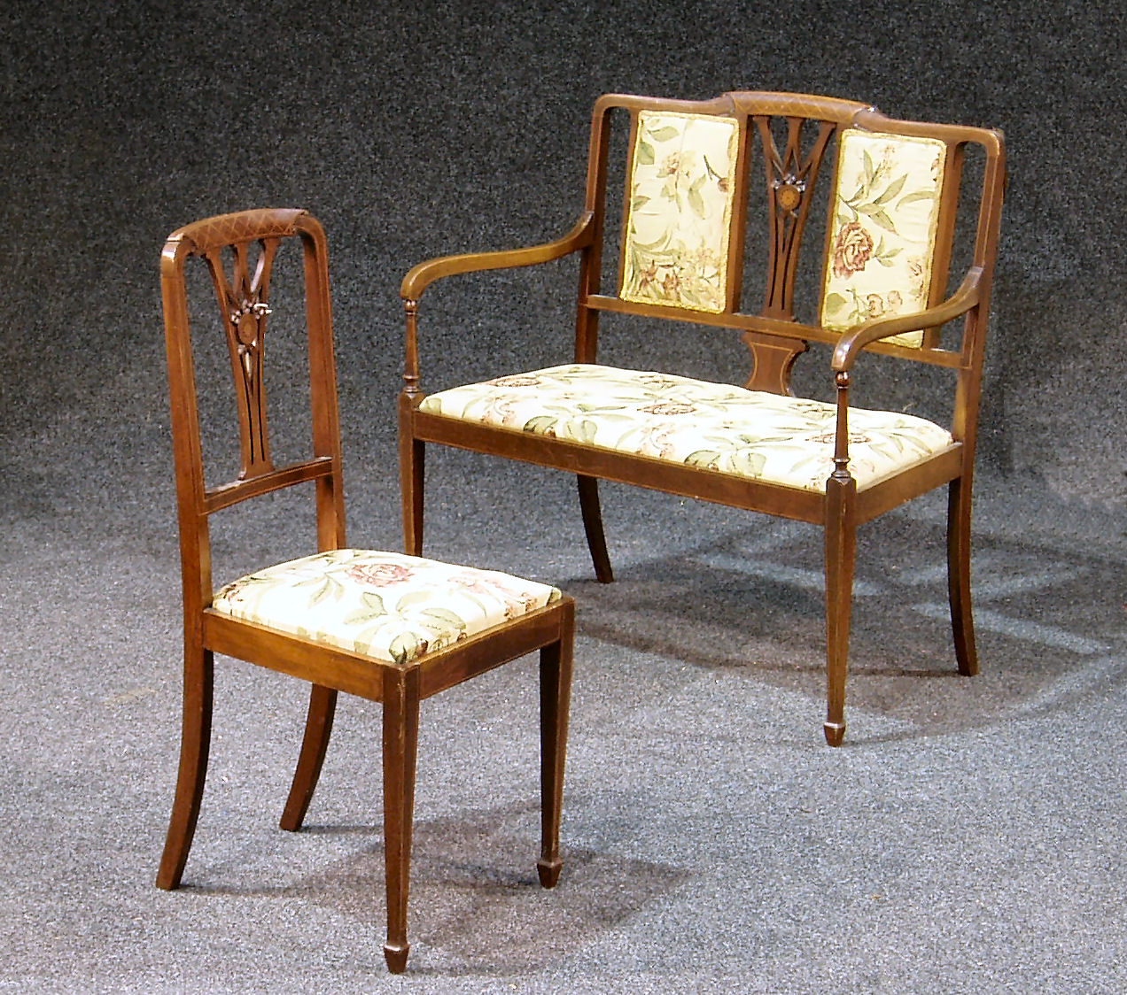 A late Victorian inlaid mahogany parlour suite,