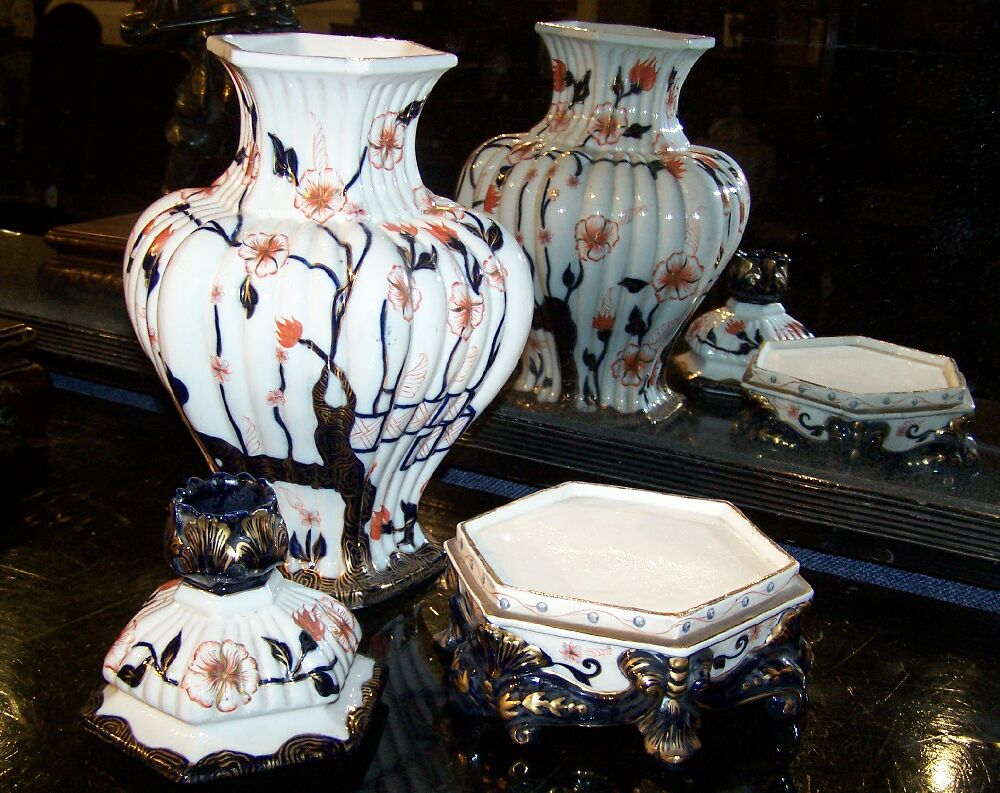 A pair of Italian porcelain Imari palette covered vases on stands