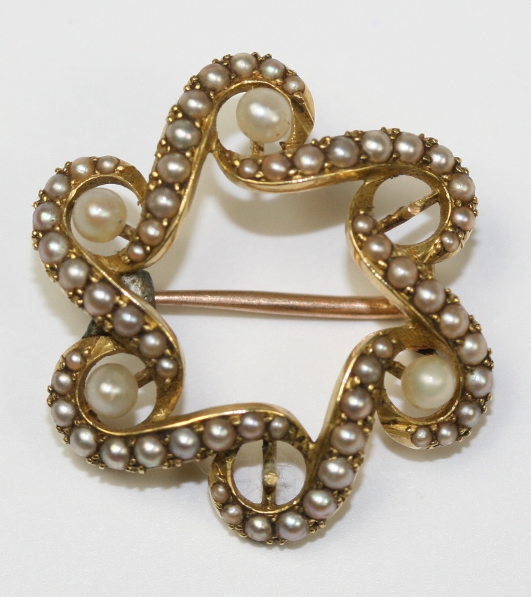 A collection of diamond and pearl set brooches