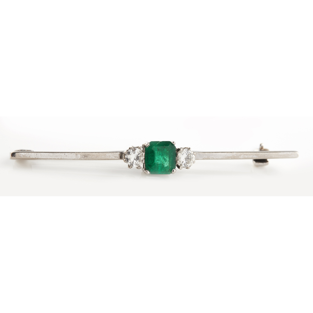 An emerald and diamond set bar brooch