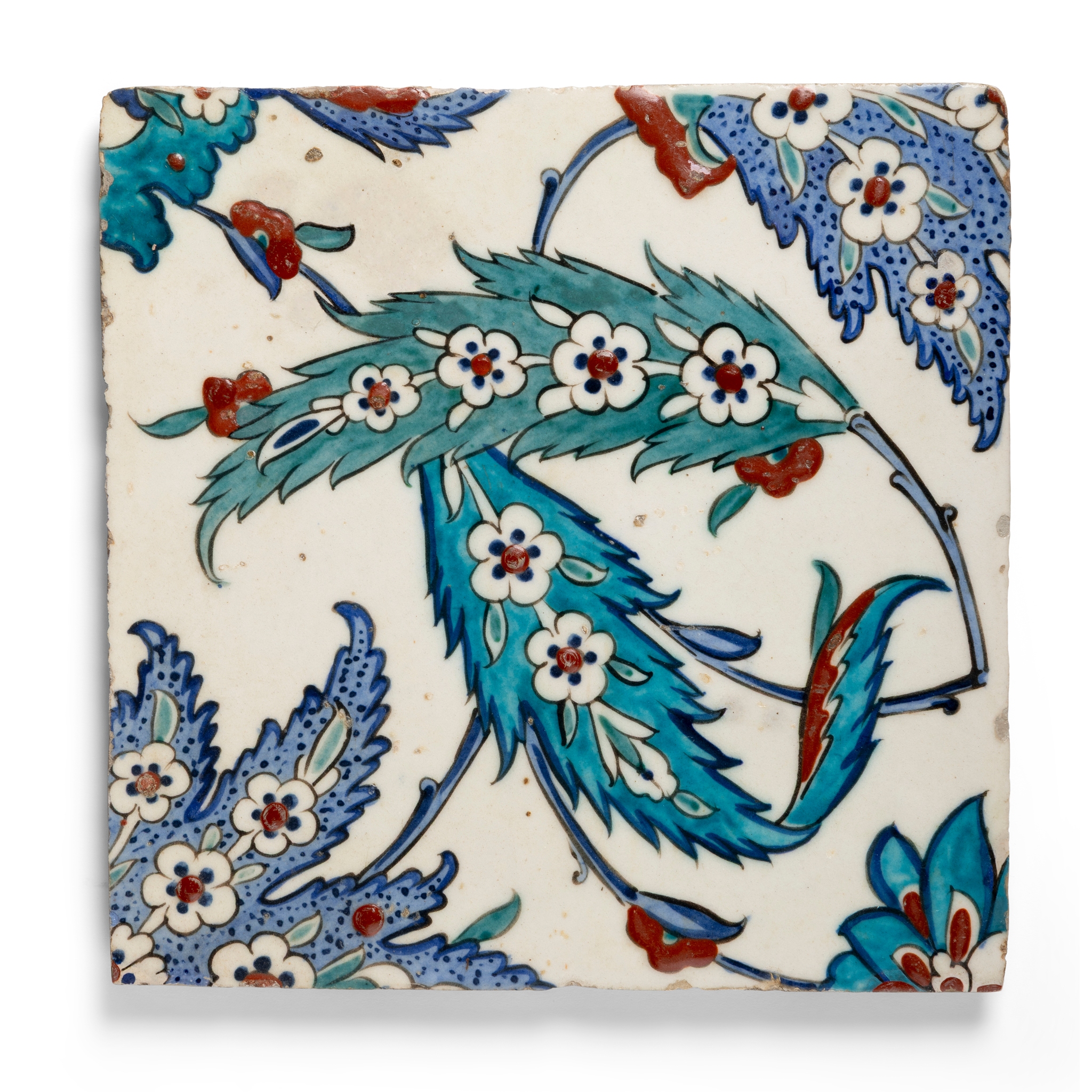 AN IZNIK POTTERY TILE DECORATED WITH 'SAZ' LEAVES