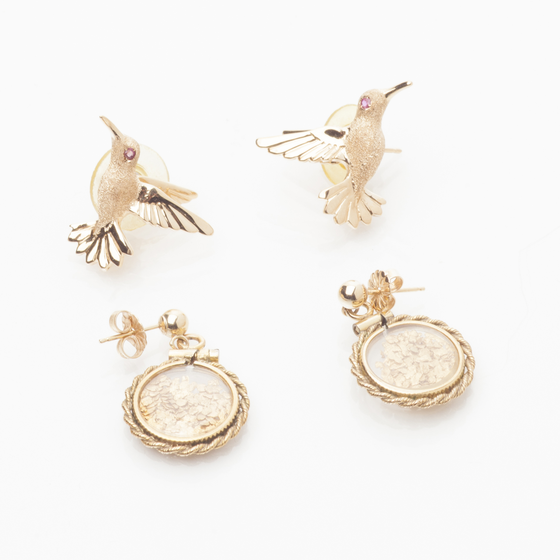 A pair of yellow metal hummingbird earrings