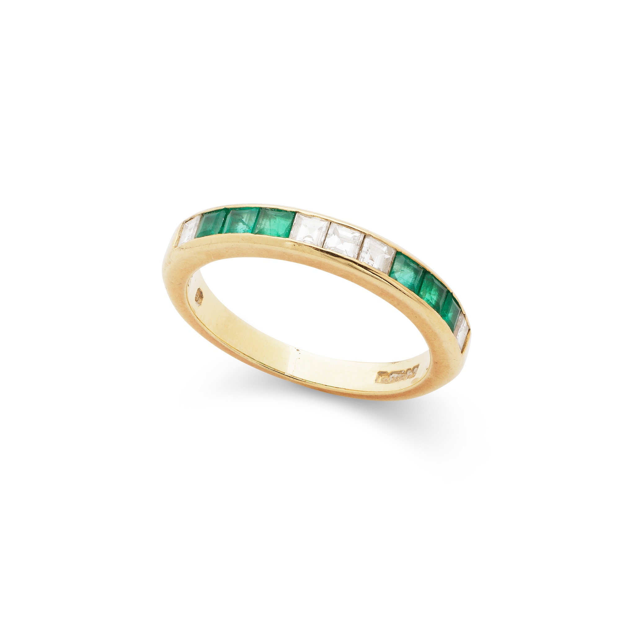 An emerald and diamond half-eternity ring