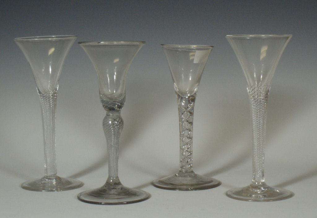 A group of four various 18th century and later air twist stem wine glasses