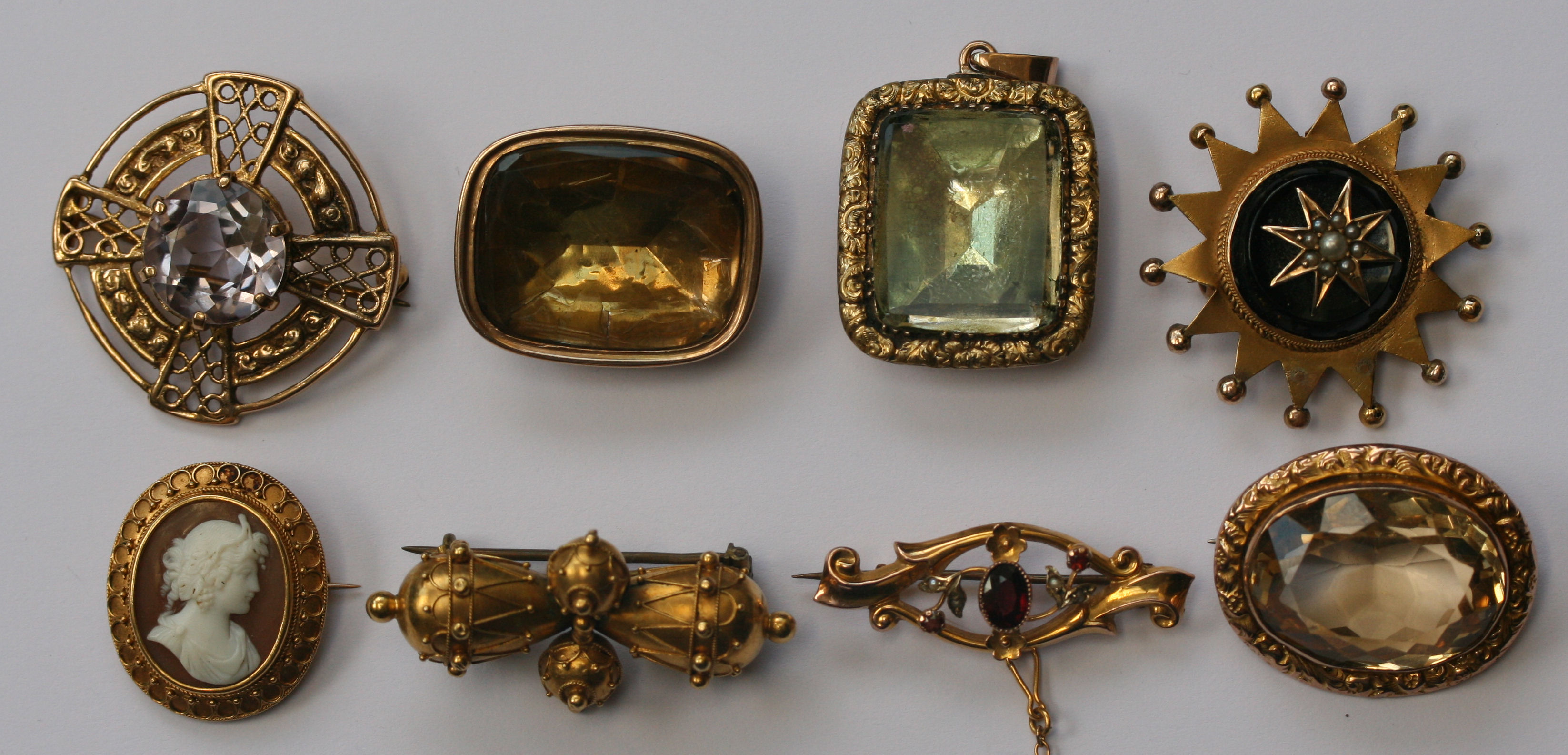 A group of gold, pearl and gem set brooches