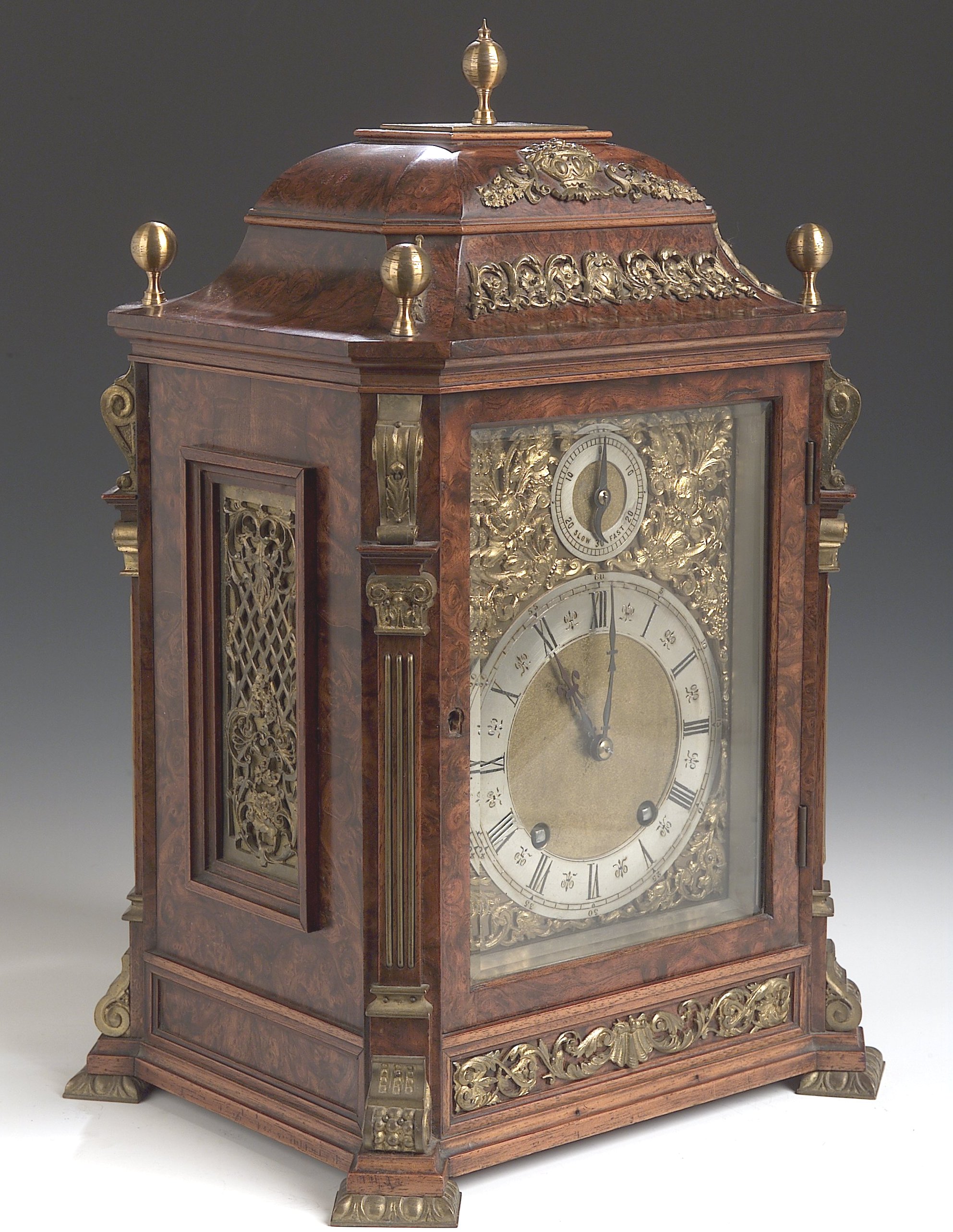 A late 19th century burr walnut and brass mounted mantel clock