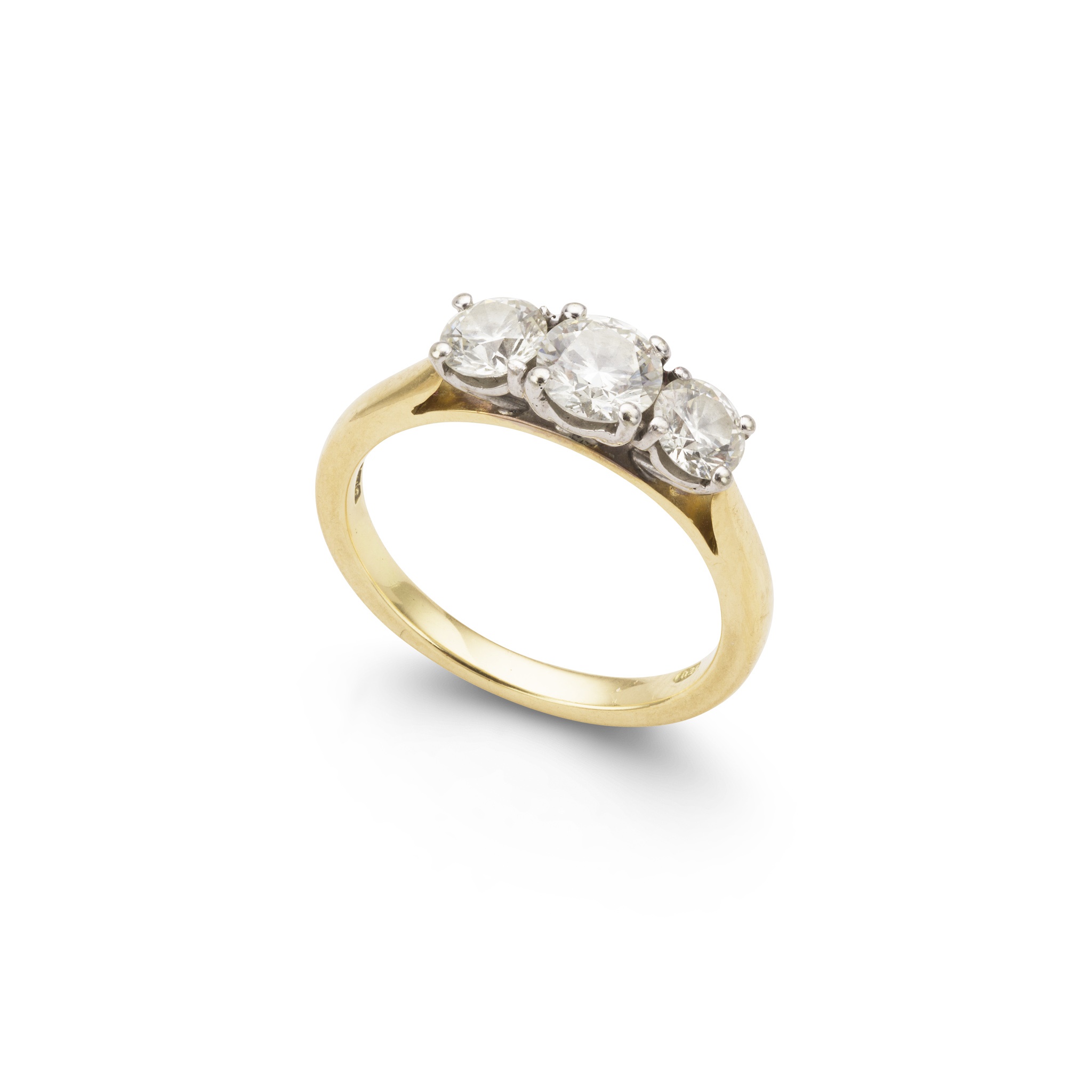 A diamond three-stone ring in 18ct yellow gold