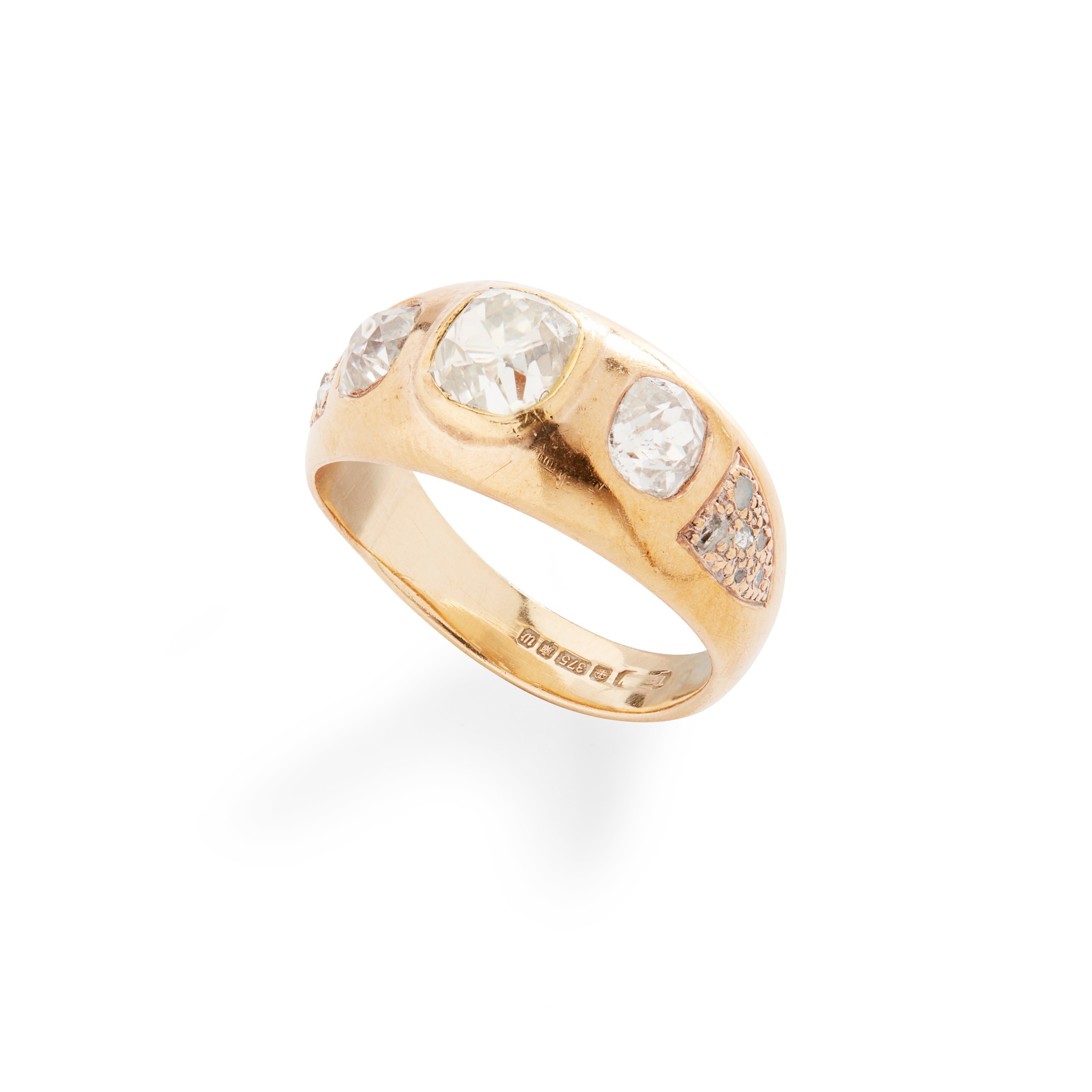 A three-stone ring in 9ct yellow gold