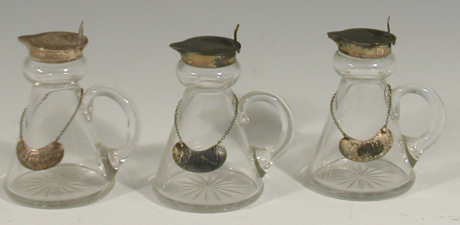 A set of three glass whisky tots,