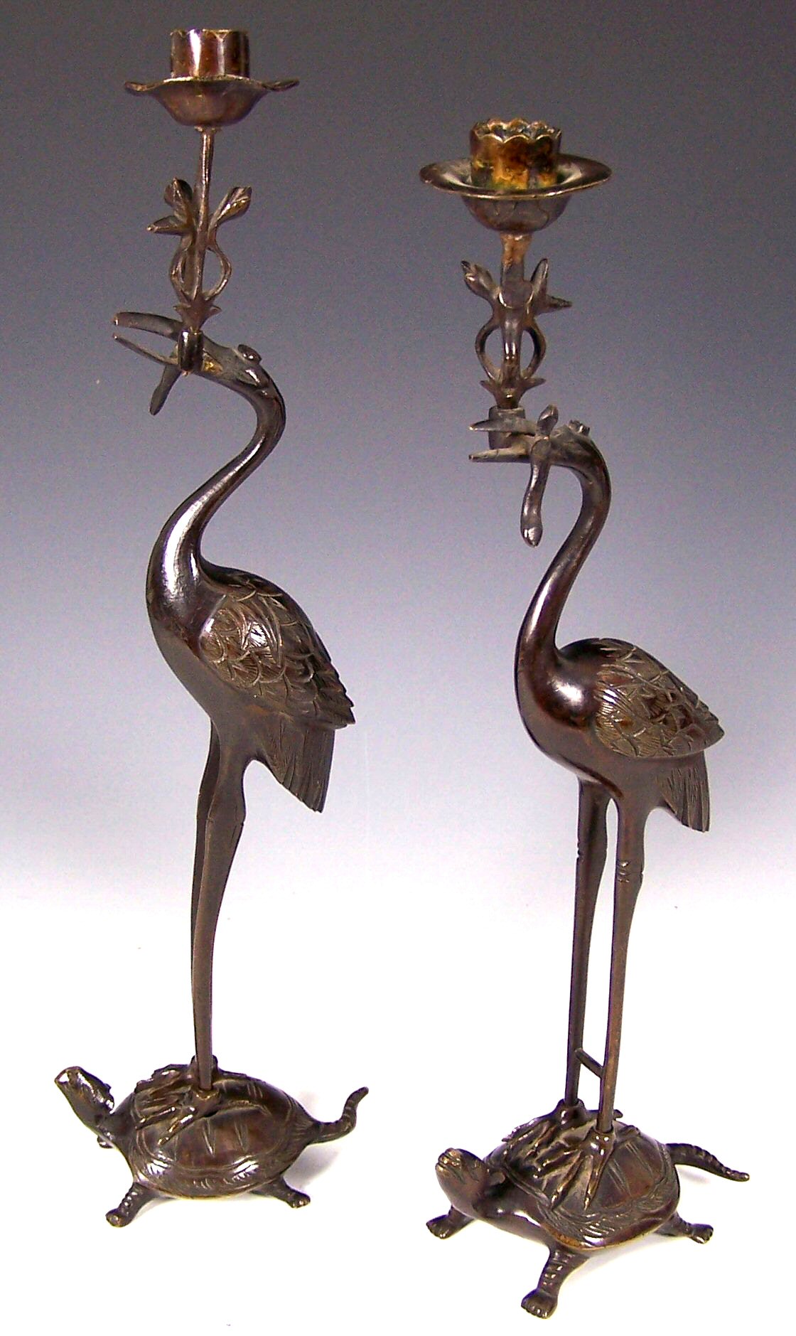 A pair of Chinese bronze crane form candlesticks,