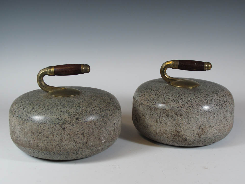 A pair of grey granite curling stones