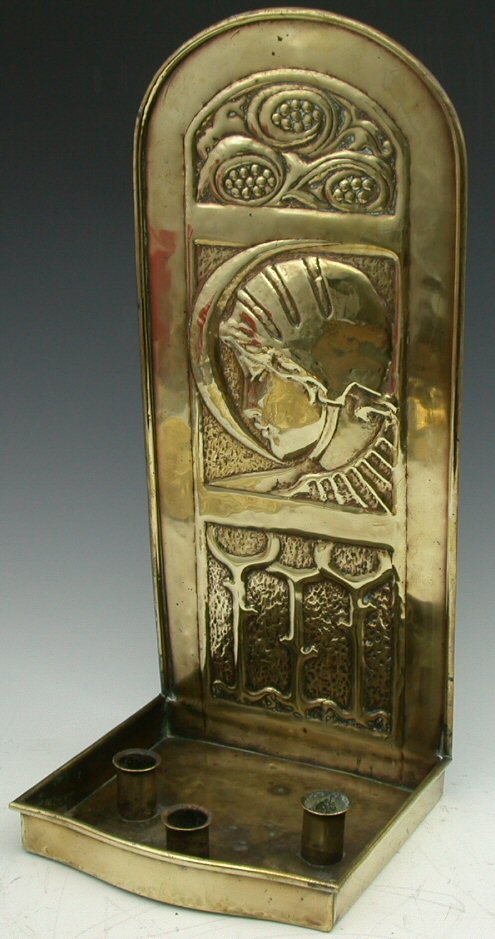 A Scottish Arts and Crafts brass candle sconce,