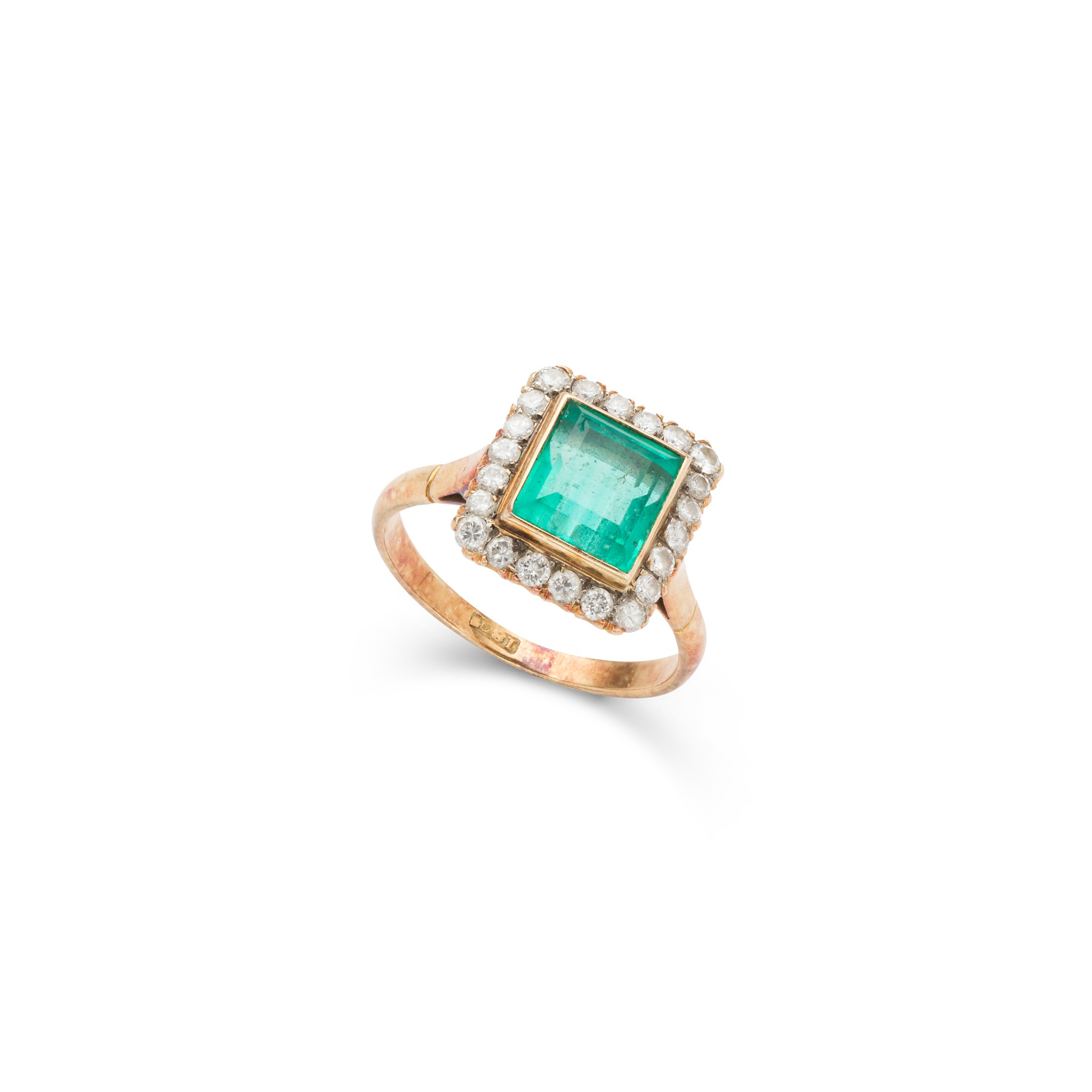 An emerald and diamond cluster ring