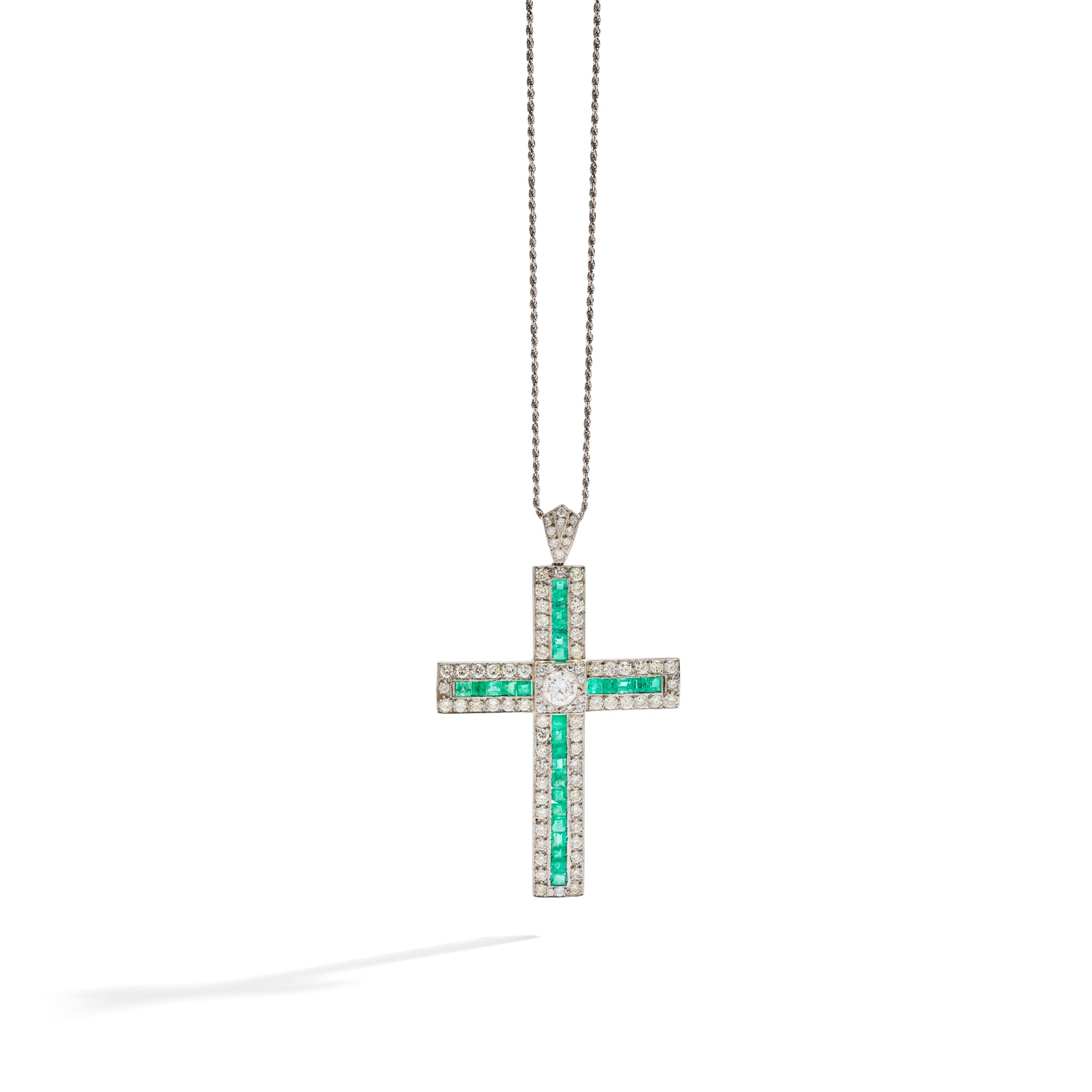 An emerald and diamond cross pendant