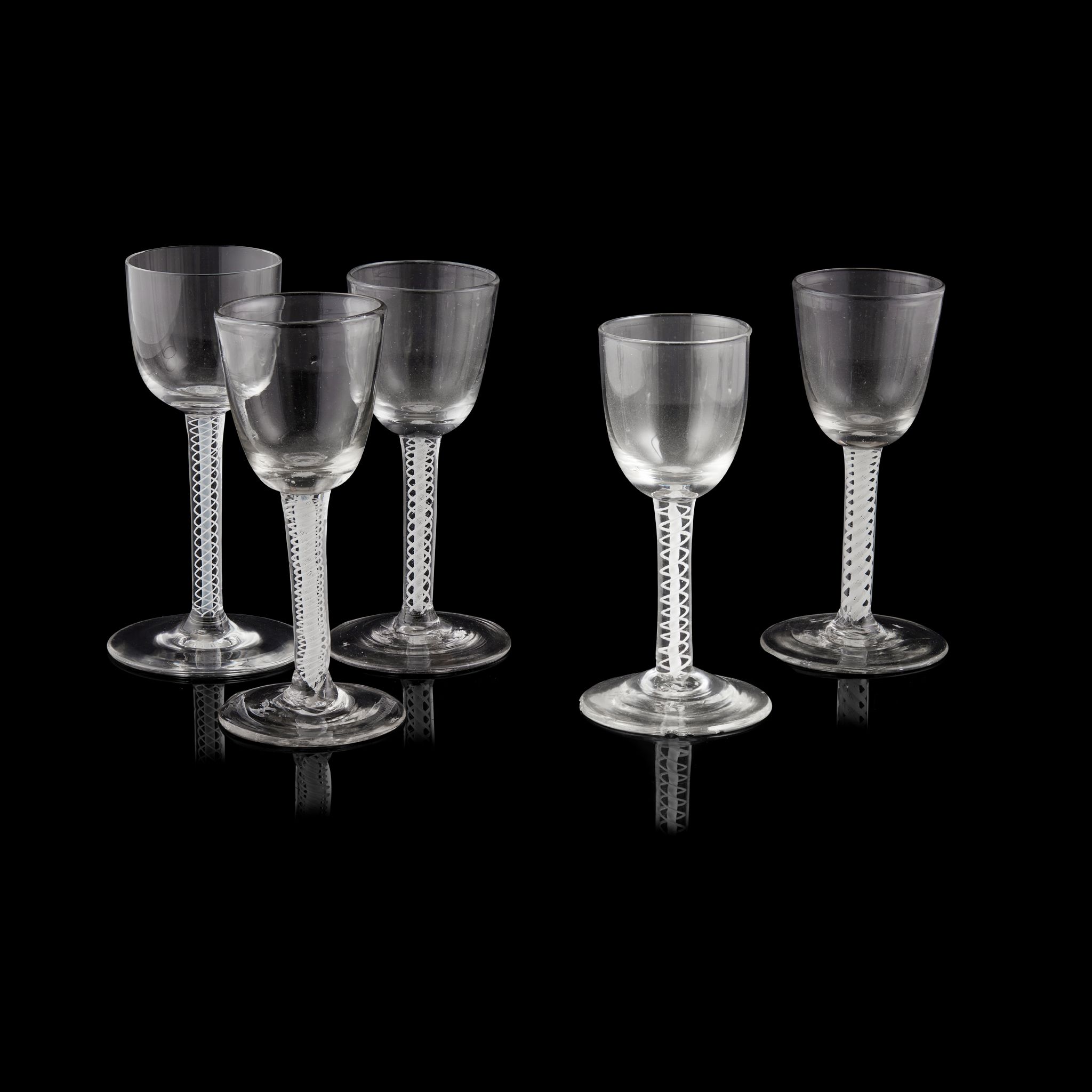 FOUR VARIOUS CONTINENTAL OPAQUE TWIST SODA GLASSES