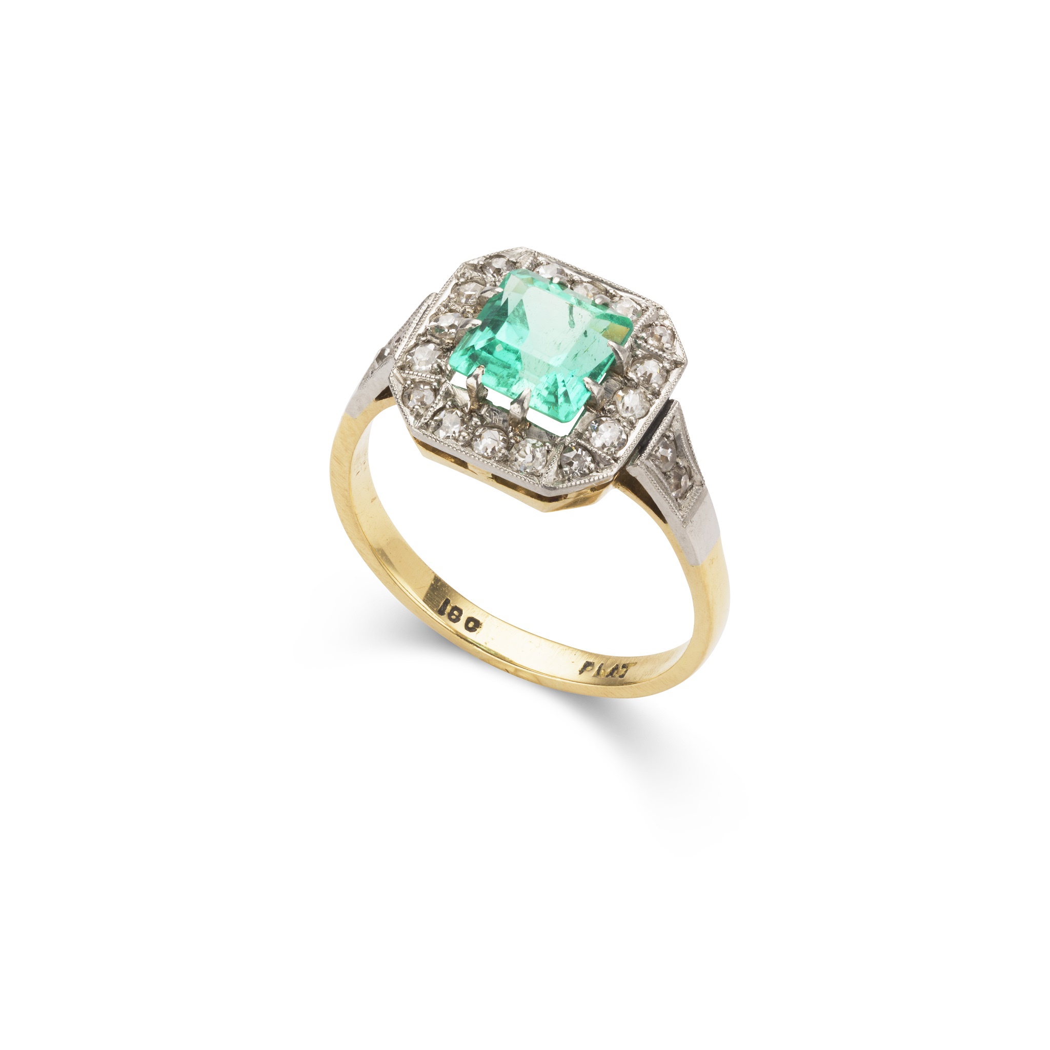 An emerald and diamond cluster ring