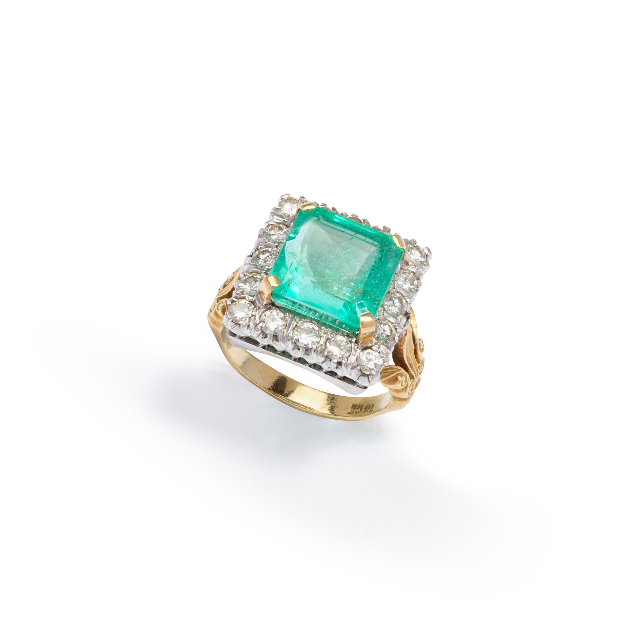 An emerald and diamond cluster ring