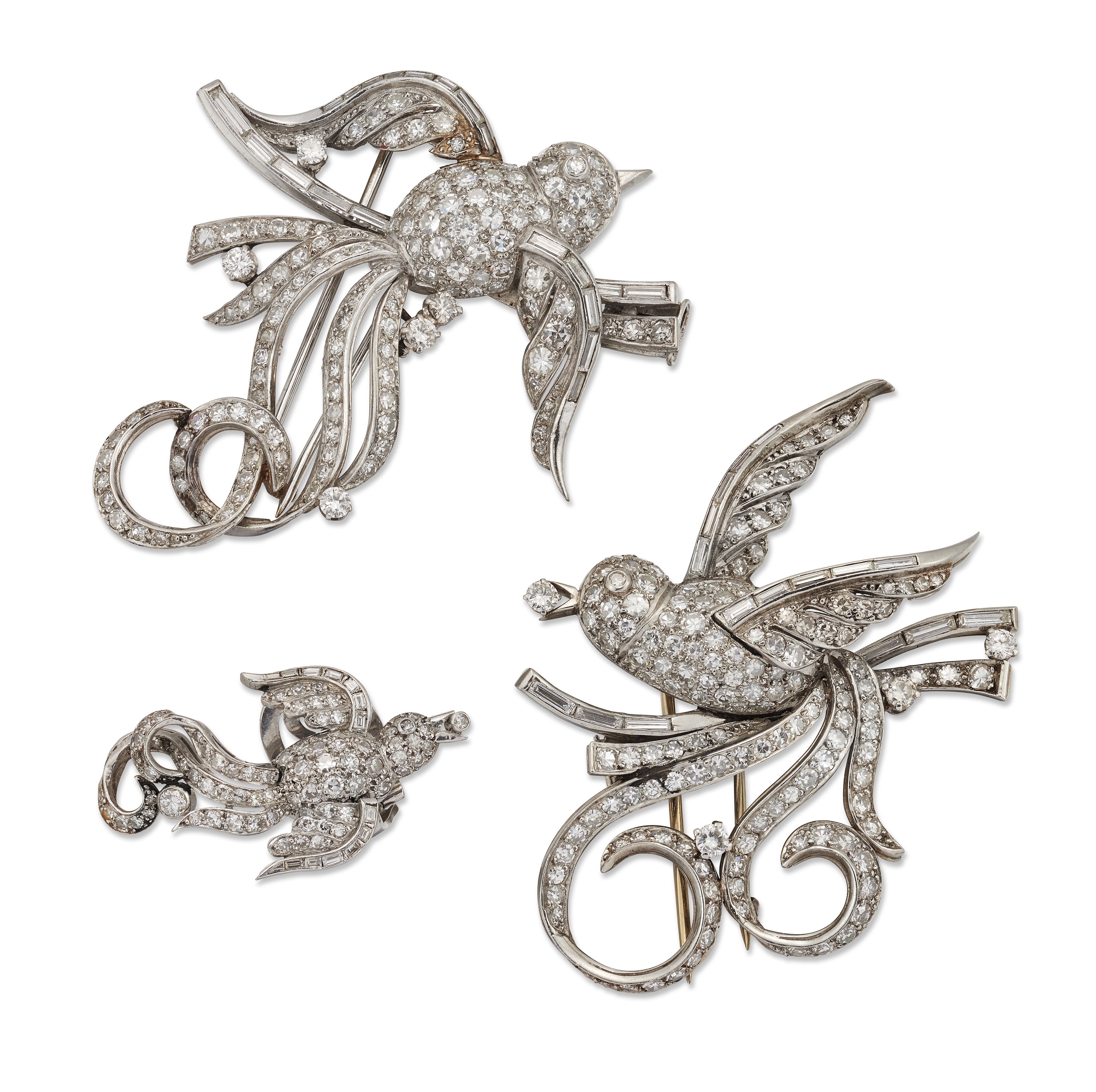 A pair of diamond-set brooches and a matching earring