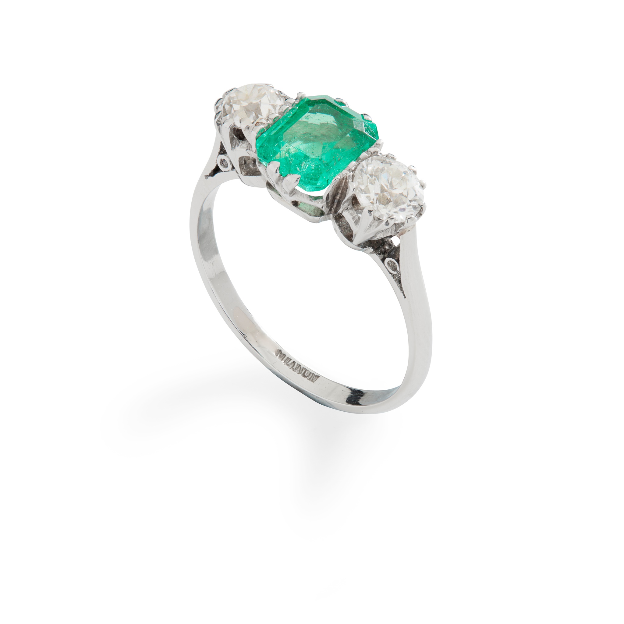 An emerald and diamond three-stone ring