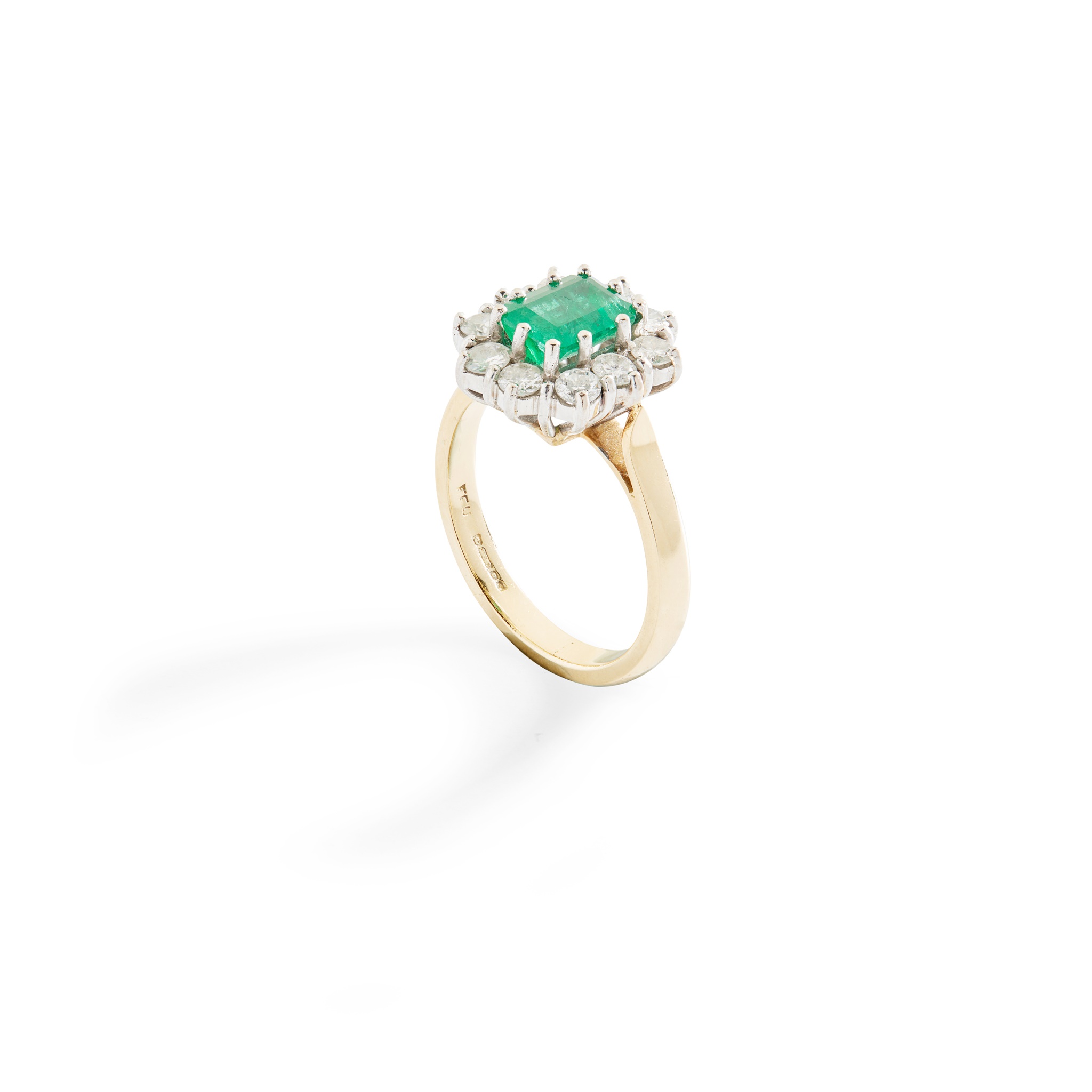 An emerald and diamond cluster ring