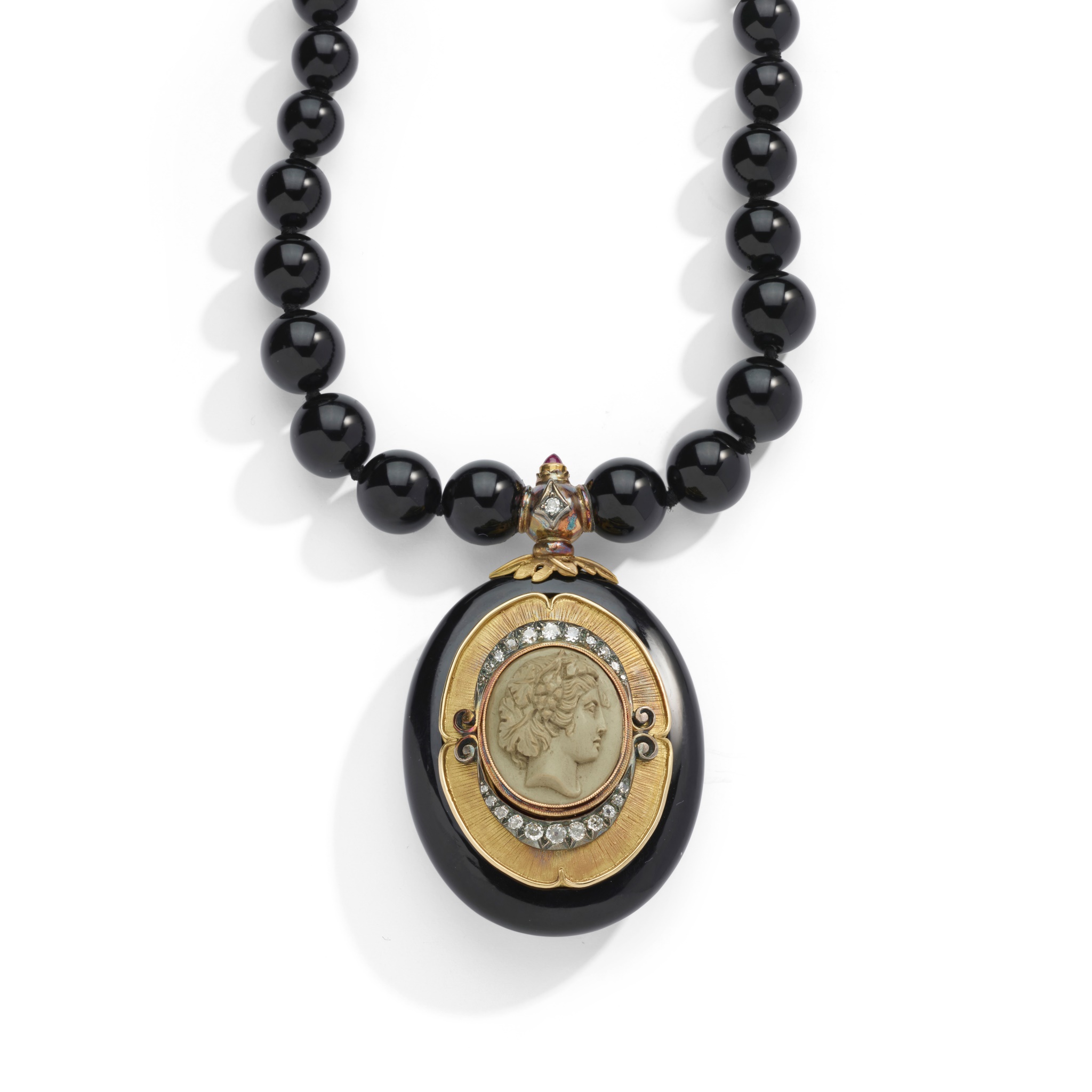 A lava cameo, diamond and onyx pendant necklace