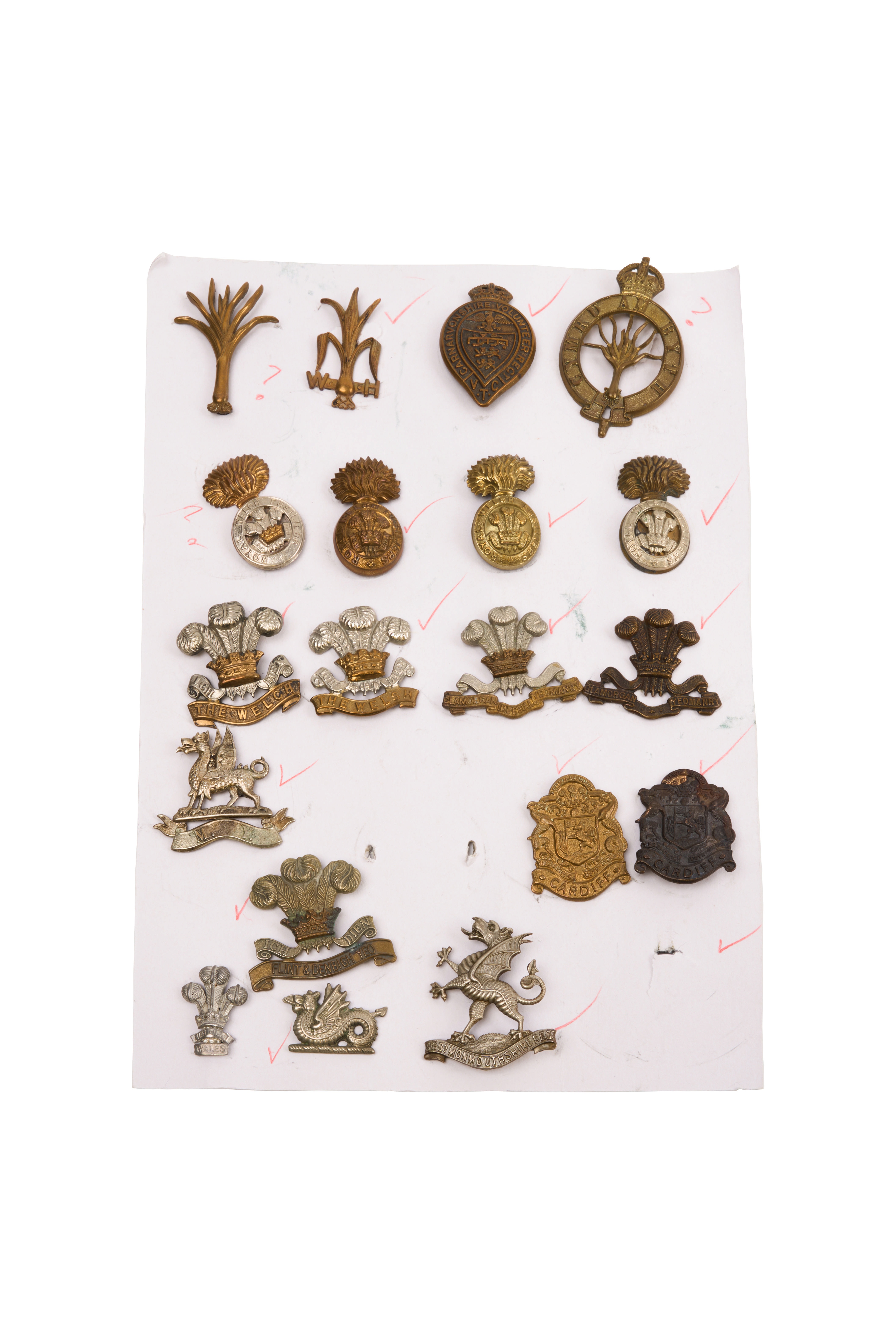 19 Welsh cap badges, Mounted on sheet