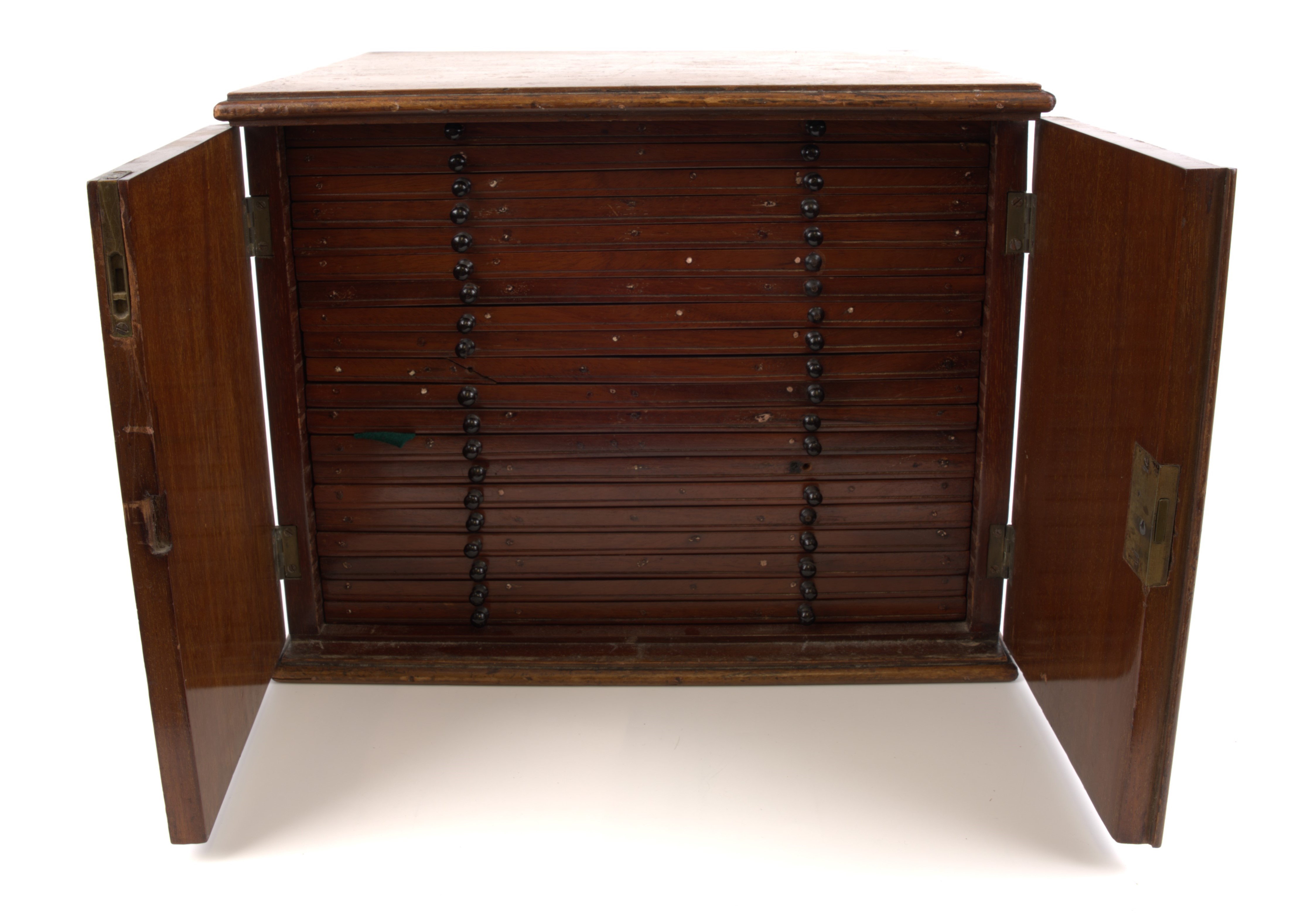 A wooden coin cabinet circa 1900, 34 x 29 x 26cm., comprising of 20 trays comprising of 8x crown size; and 12x halfcrown …