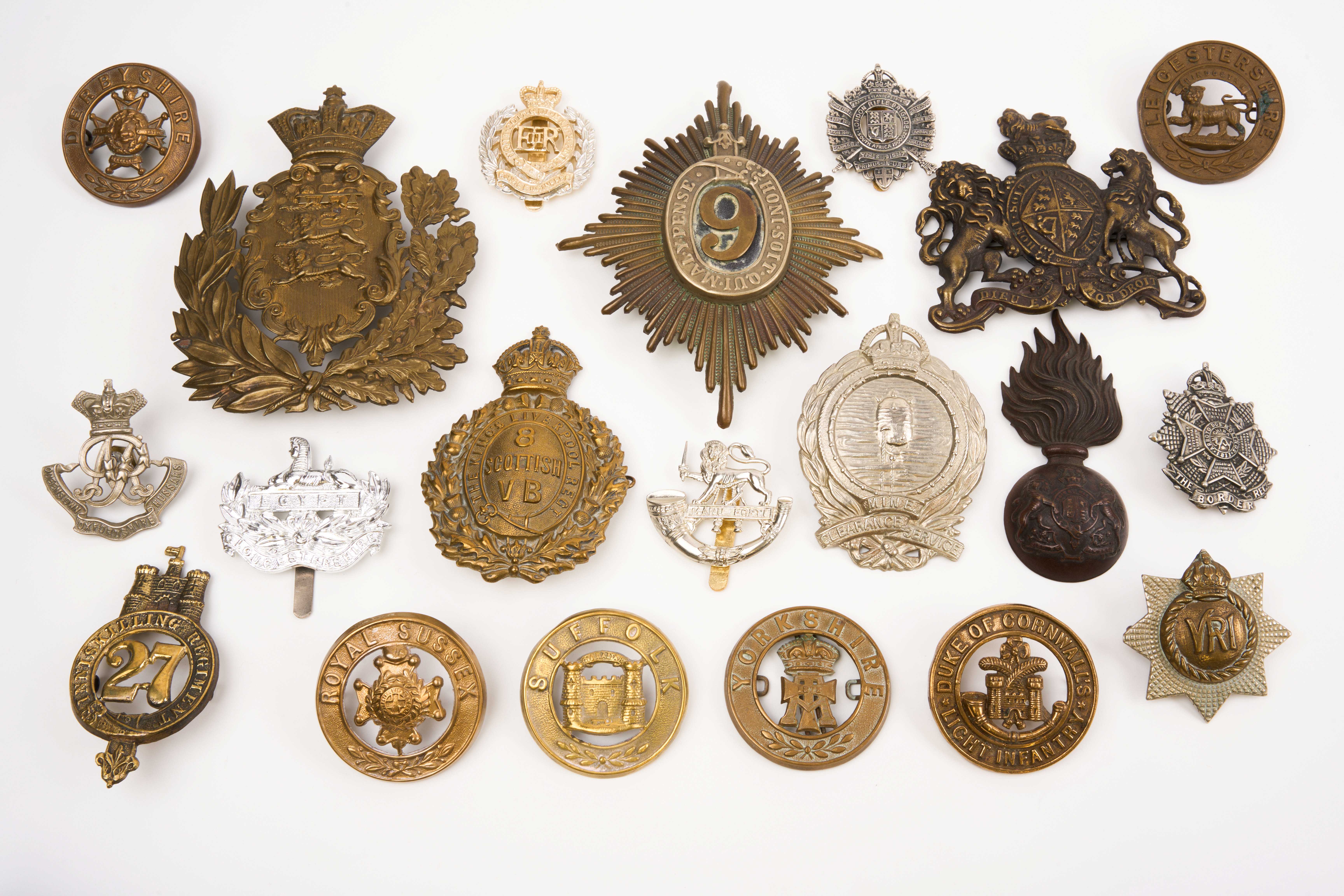 20 British and Commonwealth cap badges and helmet plates, loose in envelope