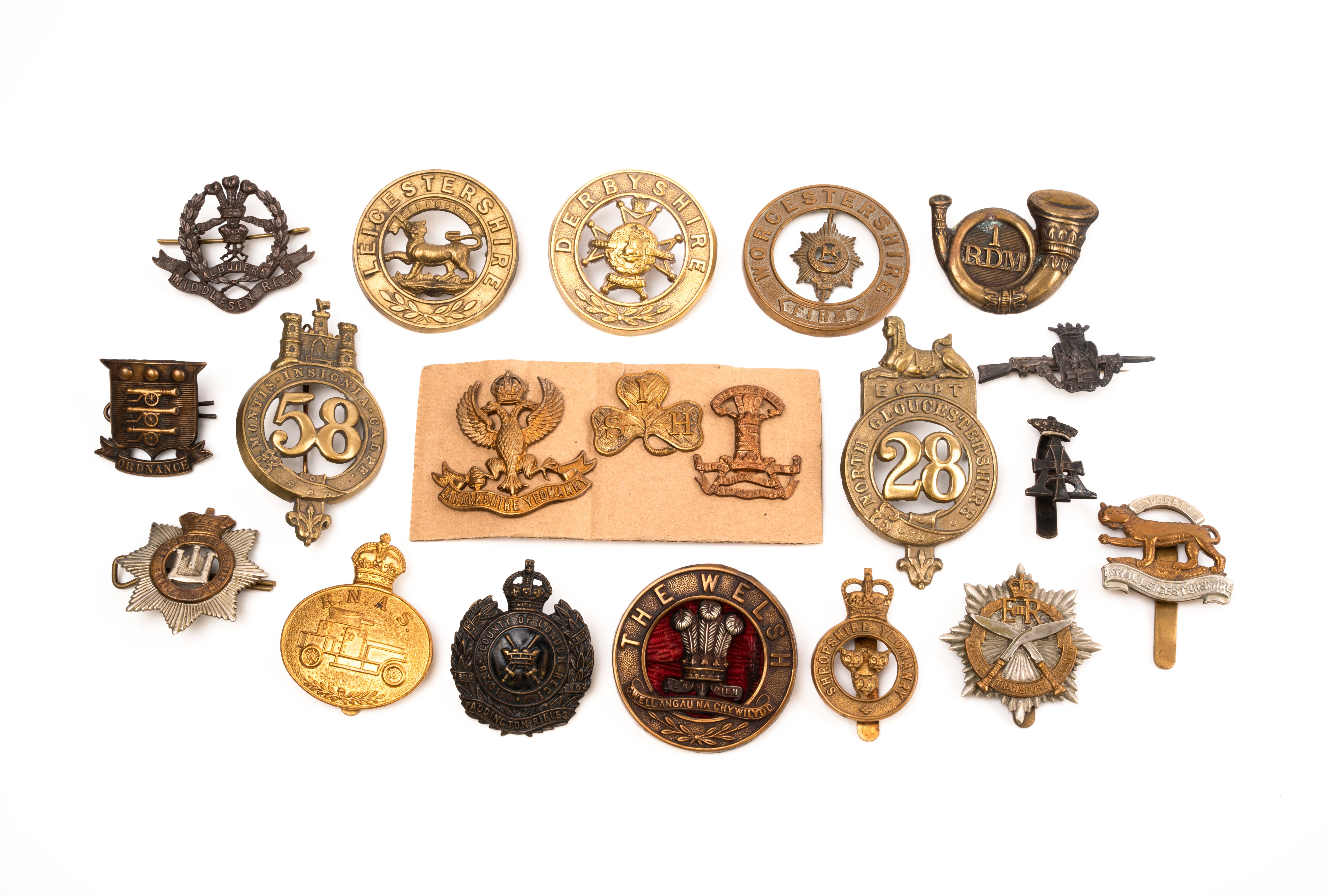 20 British and Commonwealth cap badges and helmet plates, loose in envelope