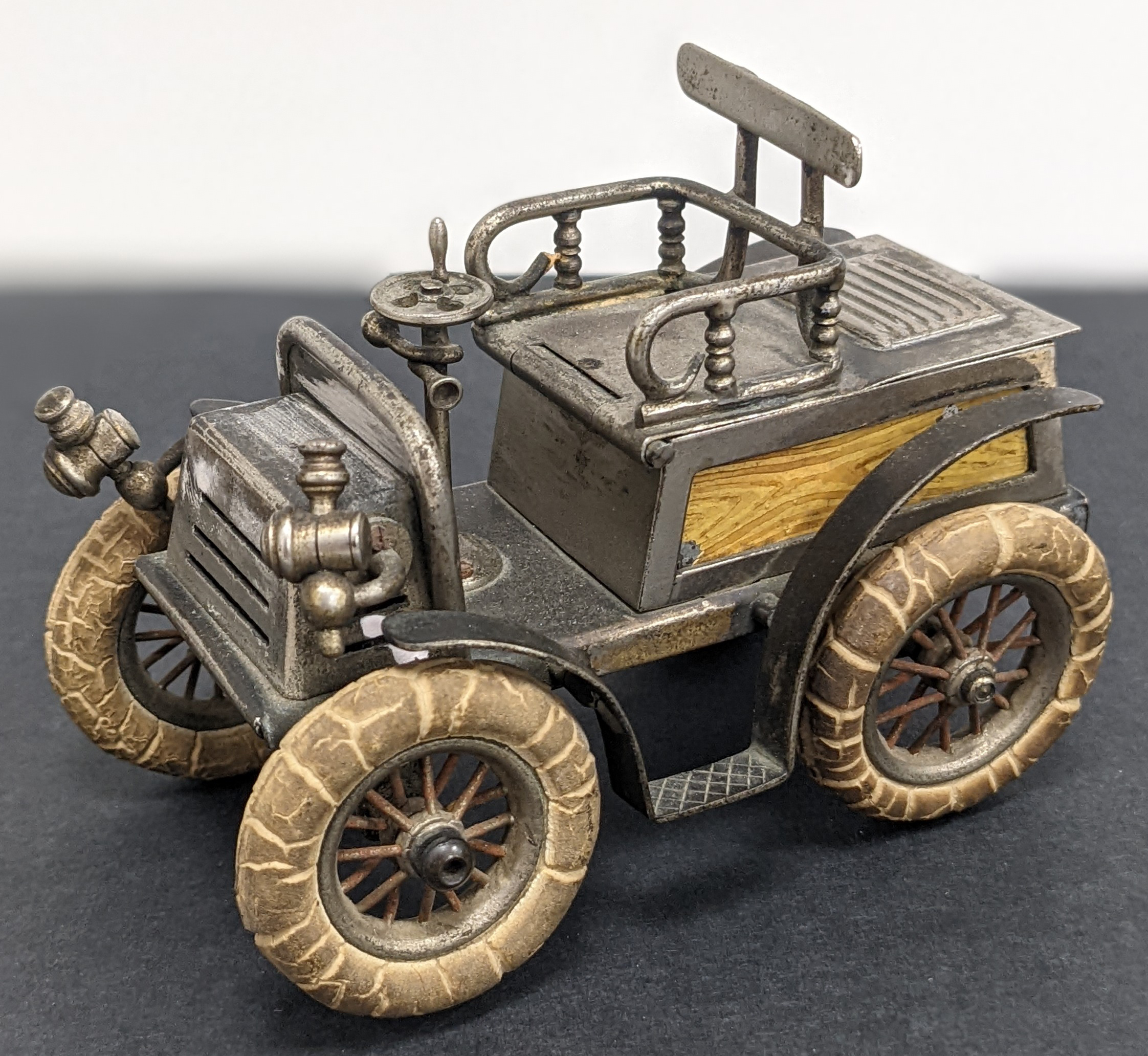 Ephemera: 1930c. a very fine metal novelty two-compartment box modelled as a car, the main body chrome plated, with spoke...